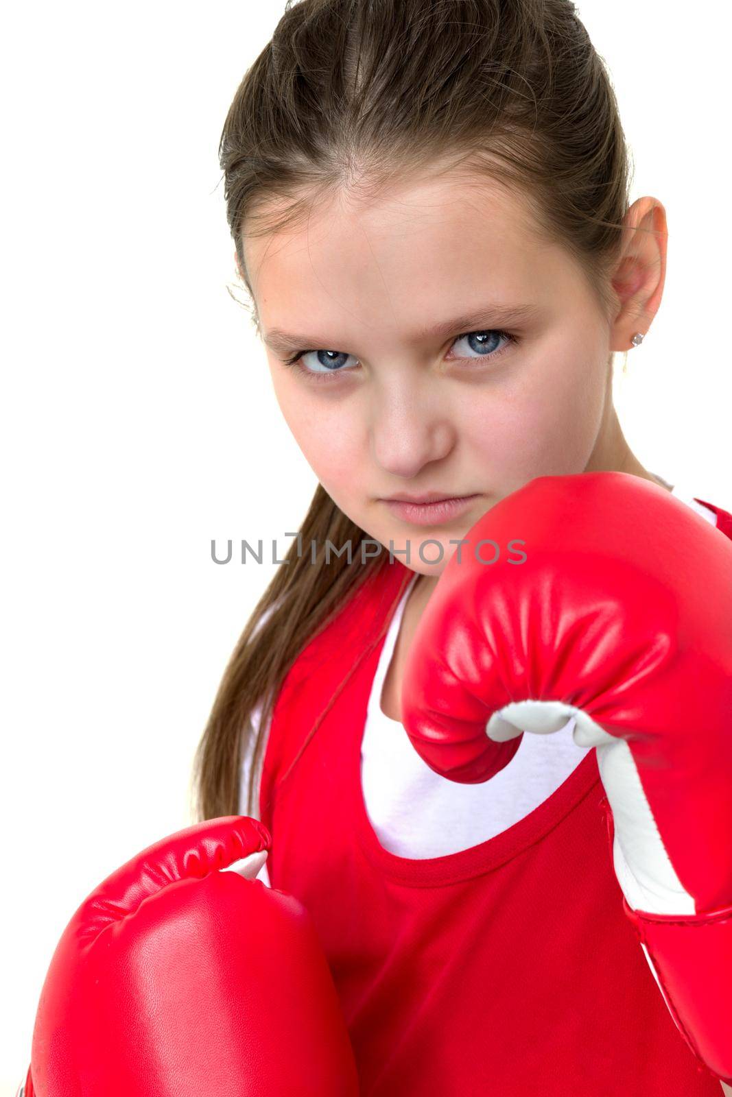 Smiling girl training in boxing gloves. Portrait of teenage girl boxer dressed sportswear ready to fight. Child posing on isolated white background. Healthy lifestyle, sport and fitness concept