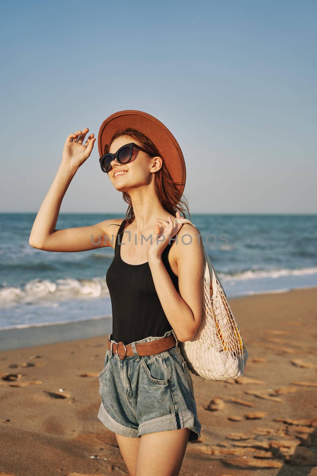 woman walking on the beach landscape sun fun lifestyle. High quality photo