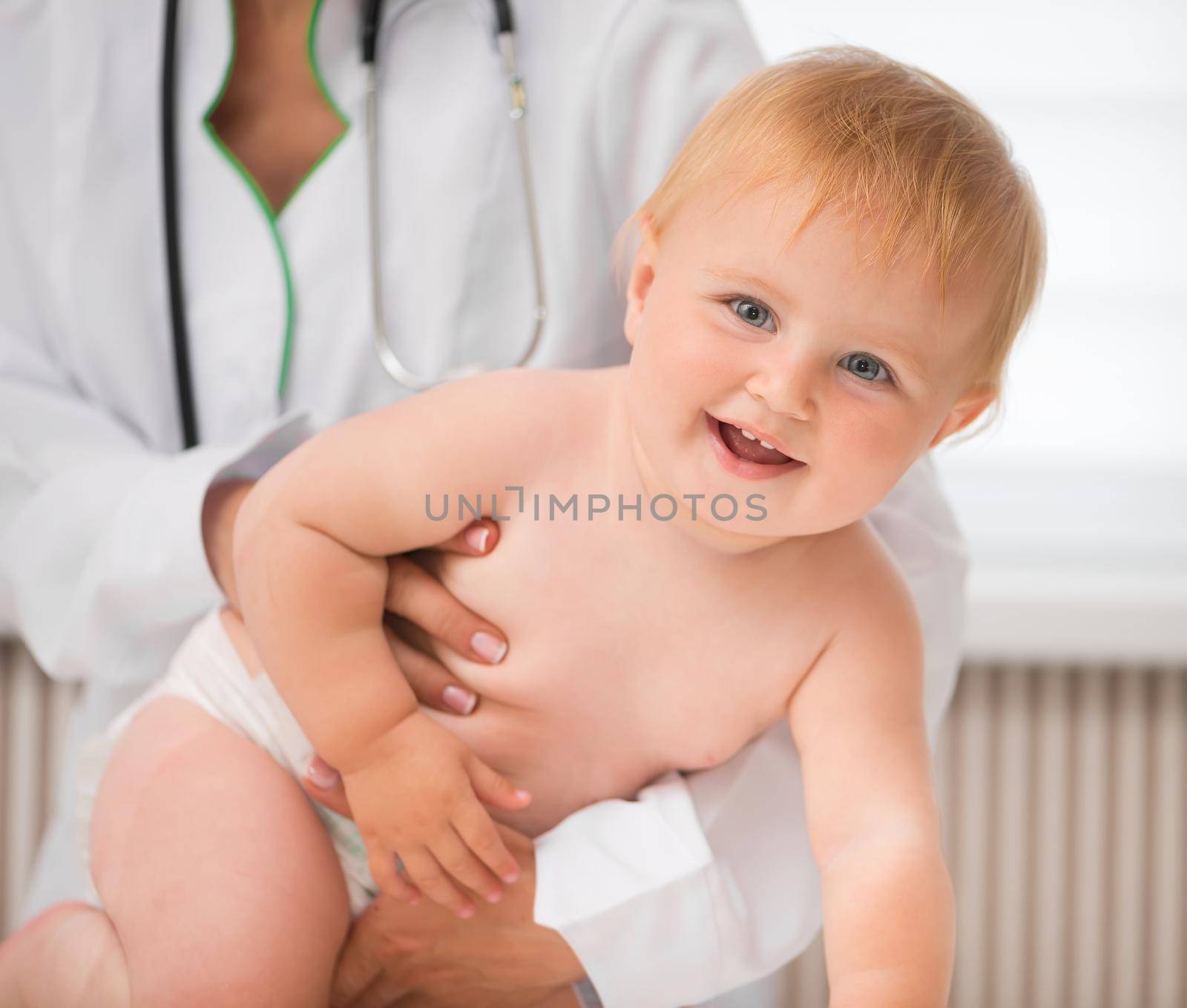 smiling baby on a doctor table by GekaSkr
