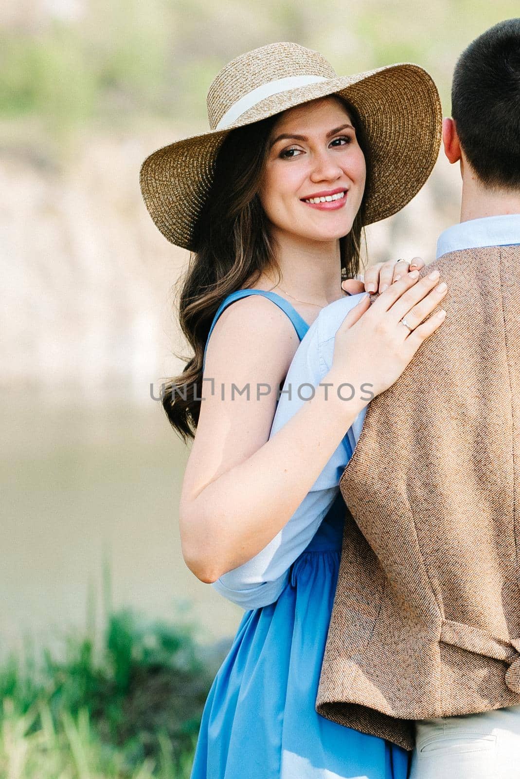 a young couple a guy and a girl are walking near a mountain lake surrounded by granite rocks