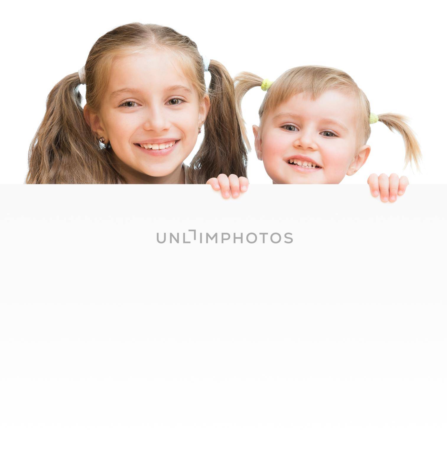 Beautiful sisters with board isolated on a white background