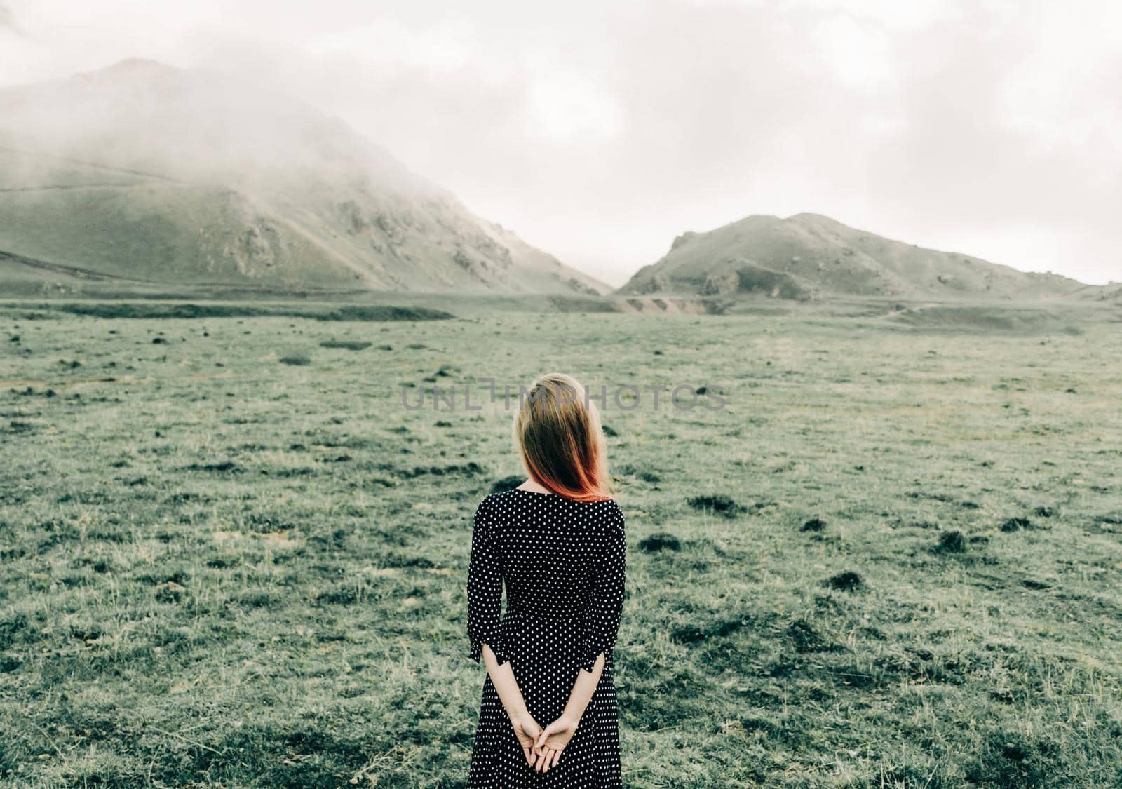 Woman in dress walking in summer mountains. by alexAleksei