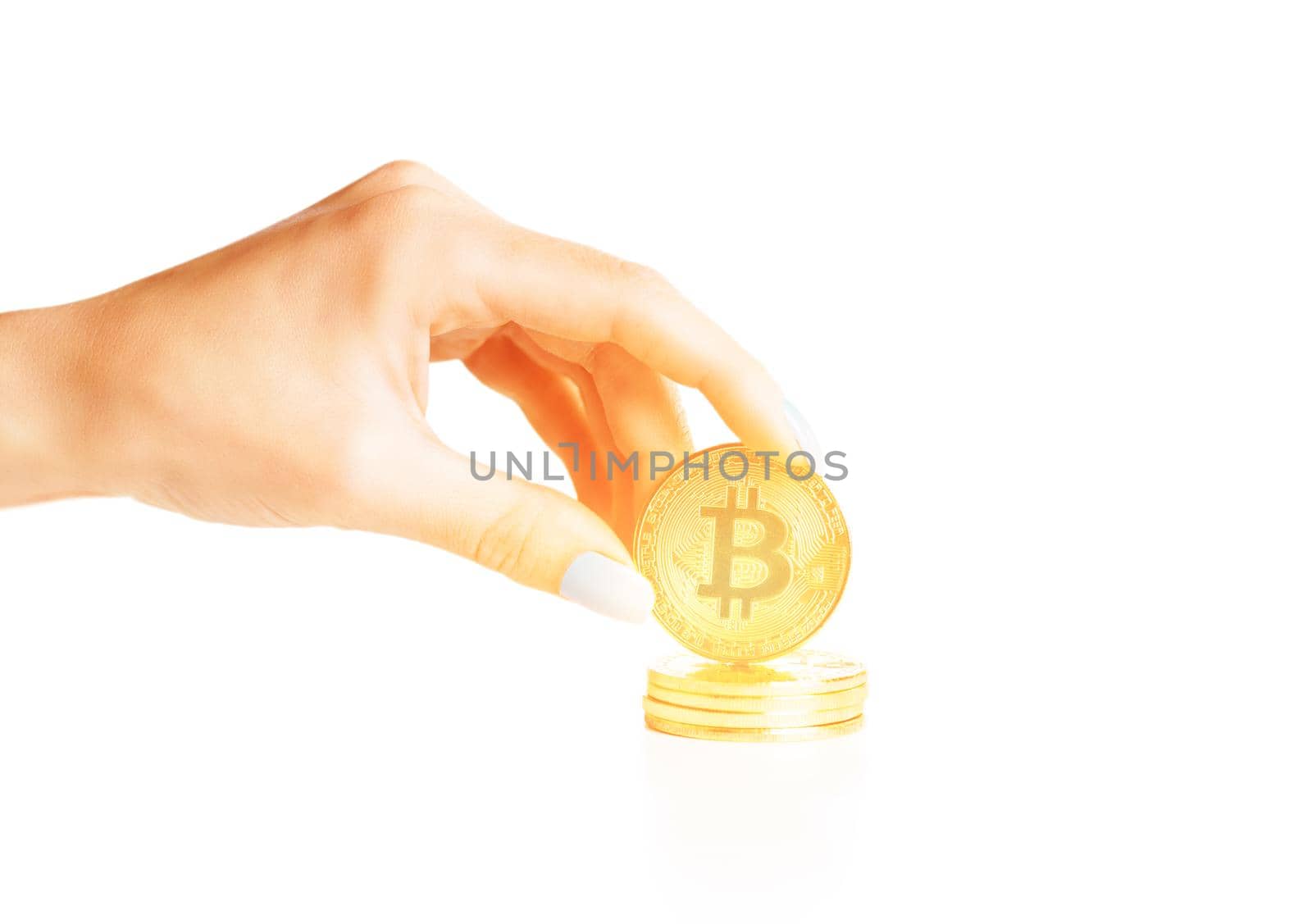 Woman hand holding stack of bitcoins - symbol of cryptocurrency.