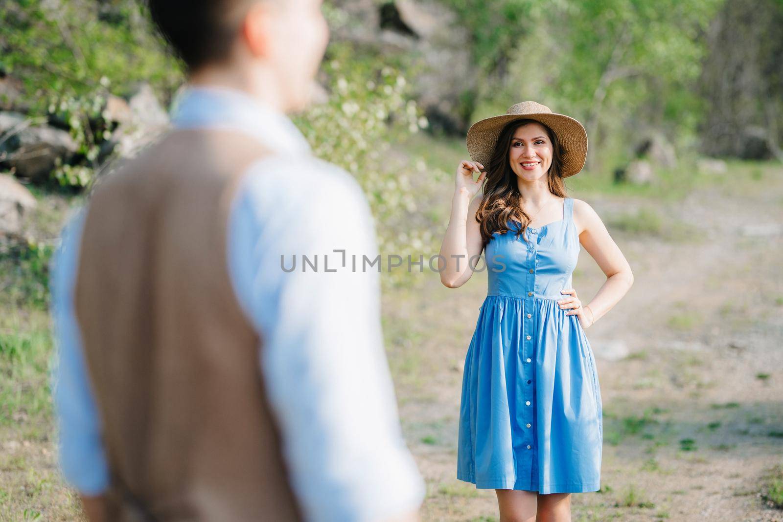 a young couple a guy and a girl are walking near a mountain lake surrounded by granite rocks