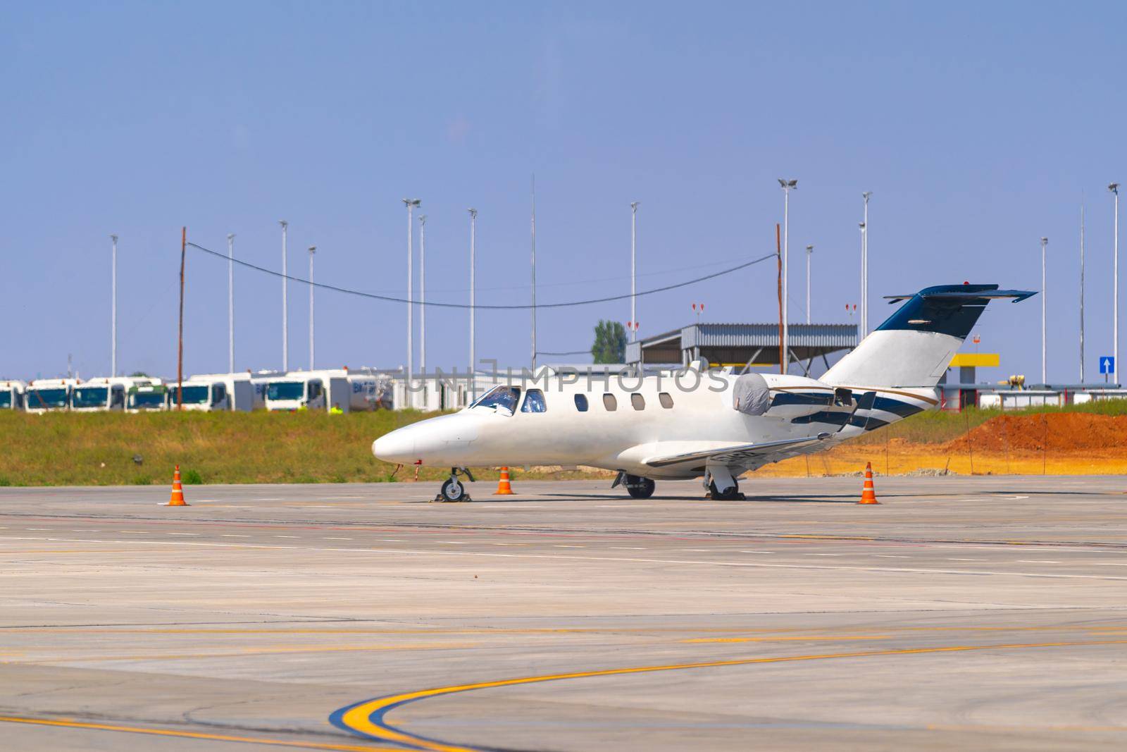 Airplane is parked near gate of airport terminal on sunny day