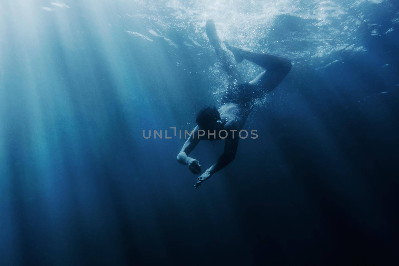 Young man snorkeling underwater, sea vacations.
