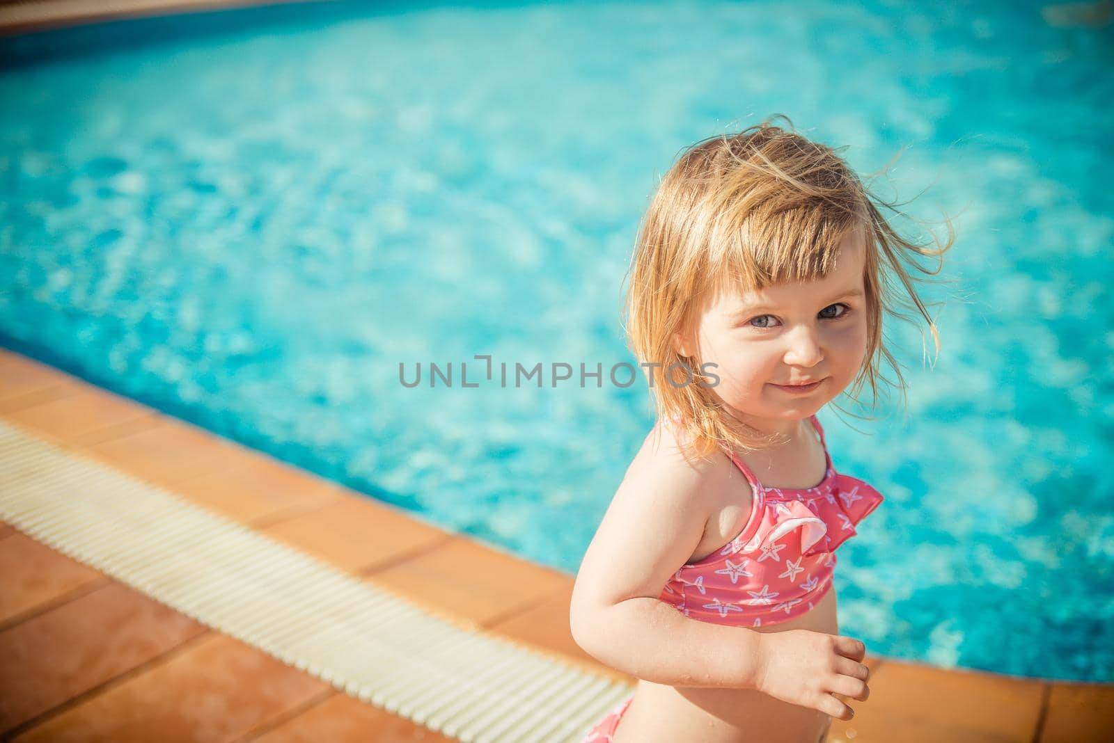 little cute girl near the pool