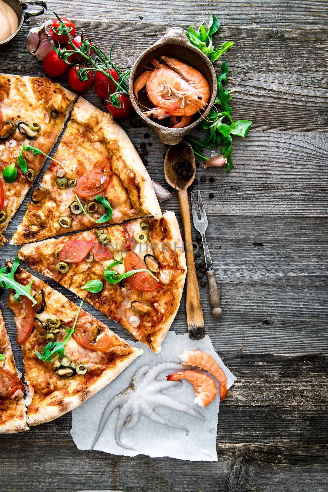delicious pizza with seafood on wooden table