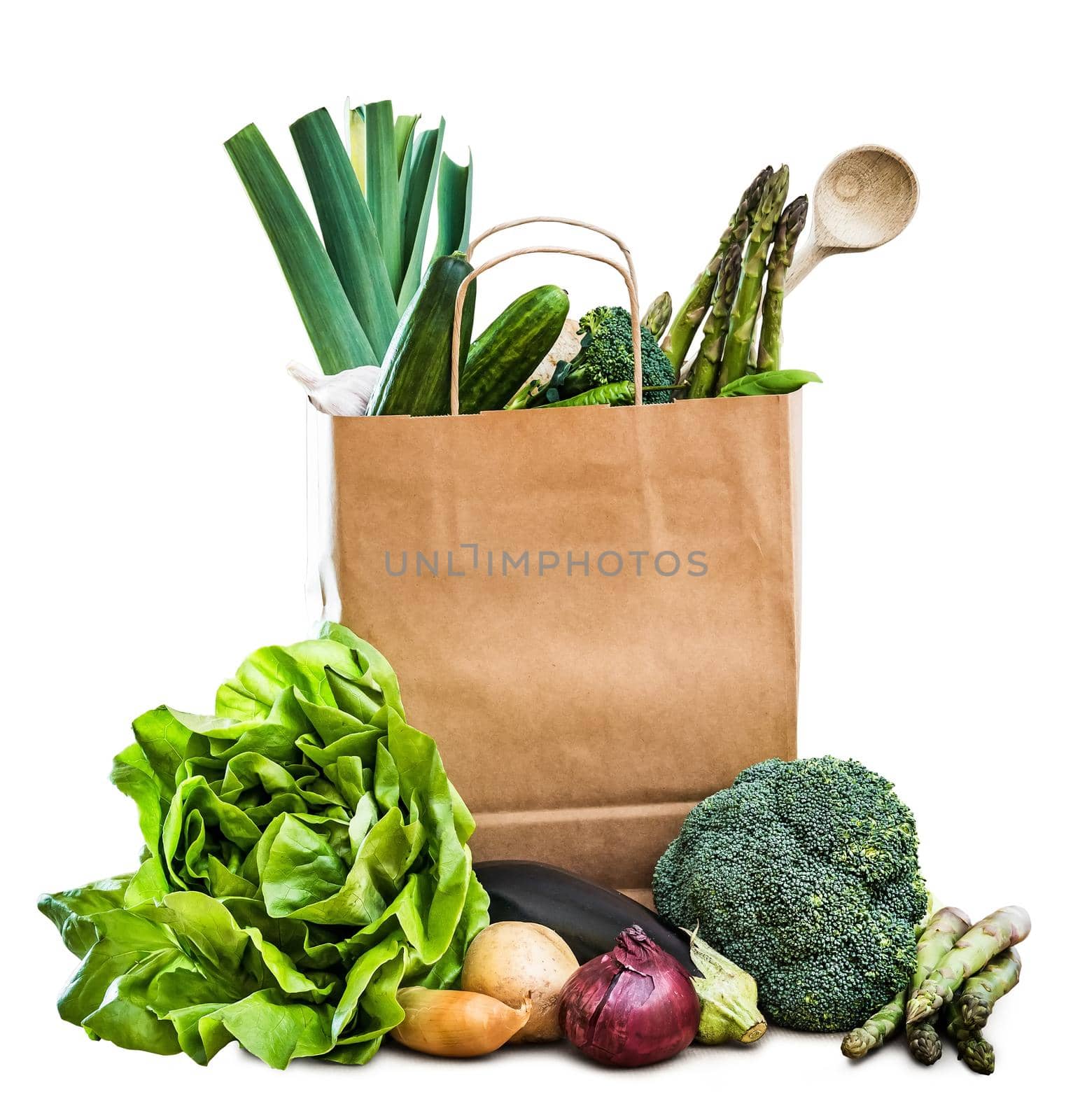 fresh vegetables in a brown paper bag isolated on a white background