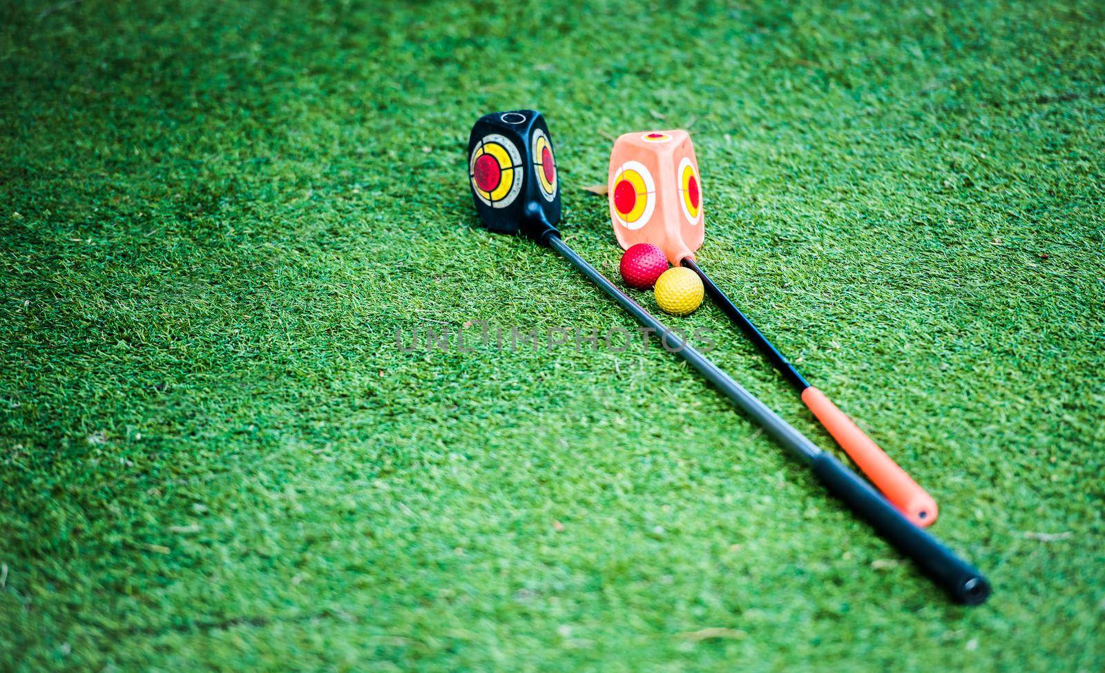 golf clubs on the green grass