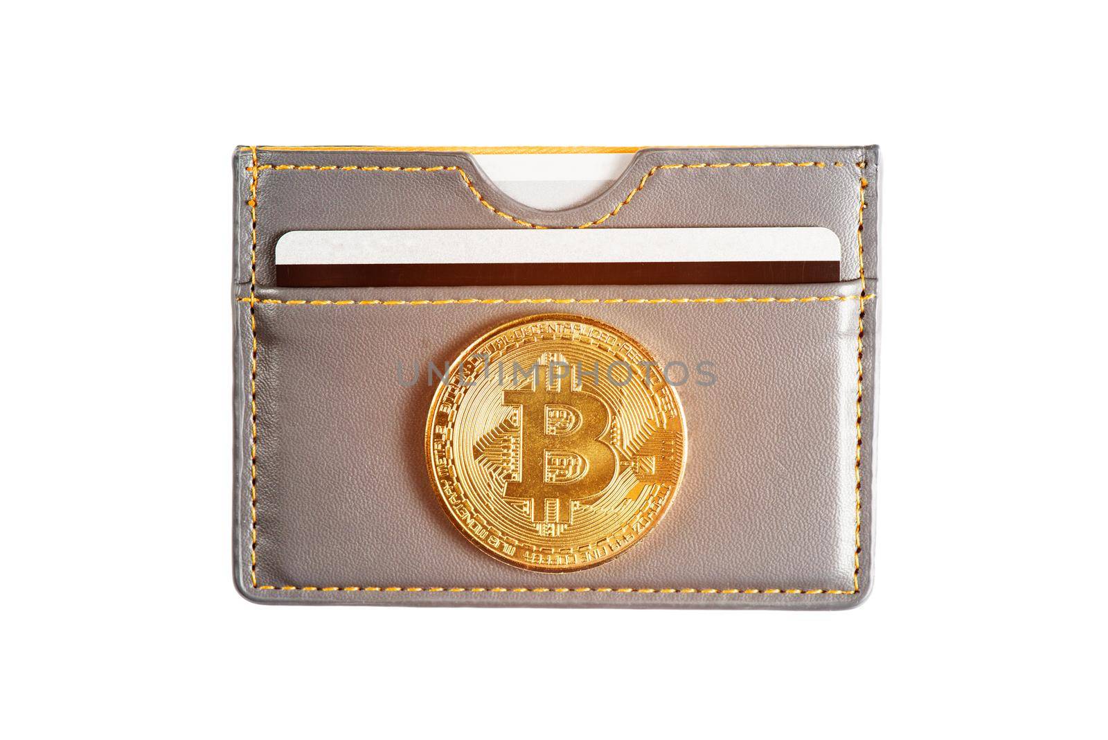 Symbol of virtual money - gold bitcoin on wallet with credit card on a white background.