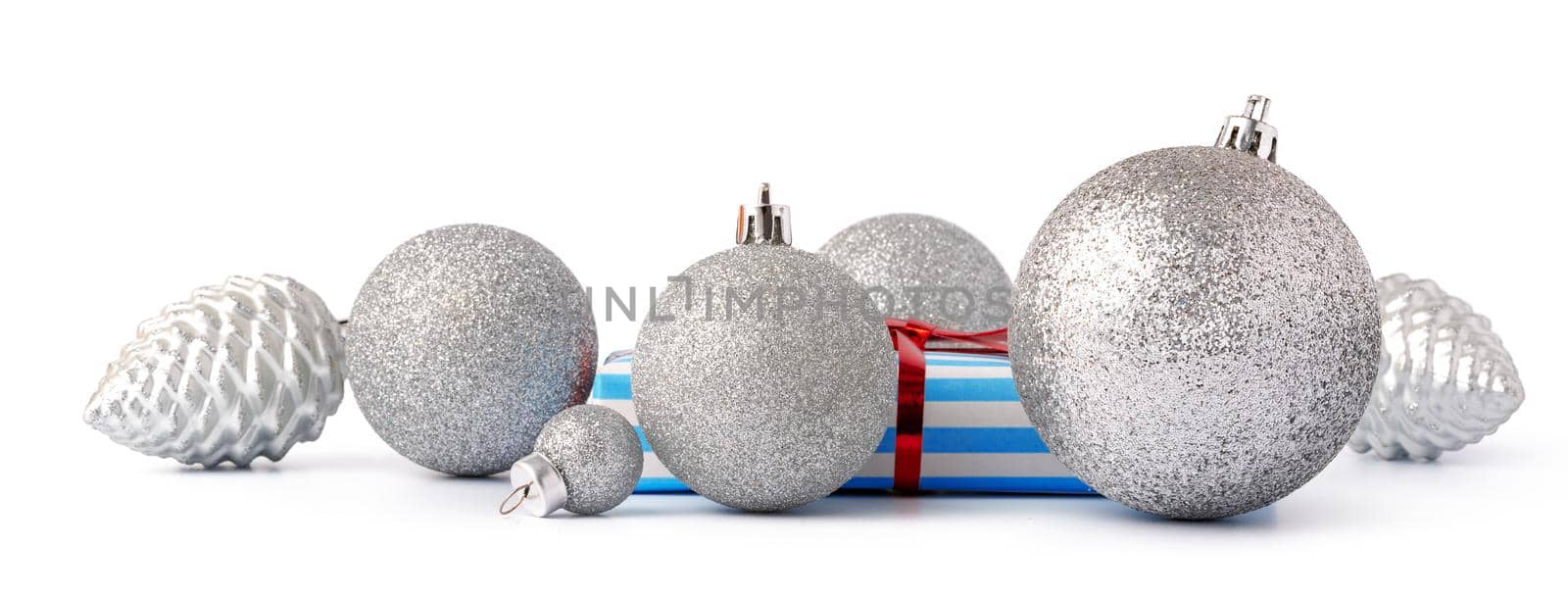 Christmas baubles and festive gift box isolated on white background, close up