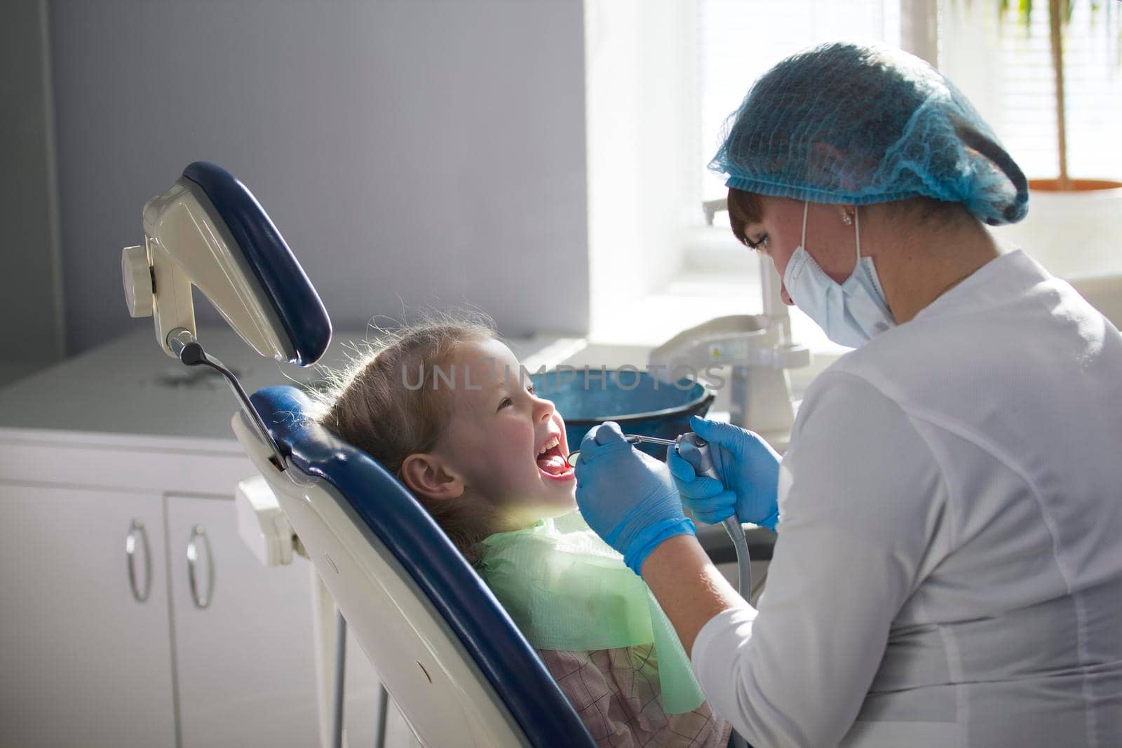 Little child in stomatology chair - children dentistry, close up