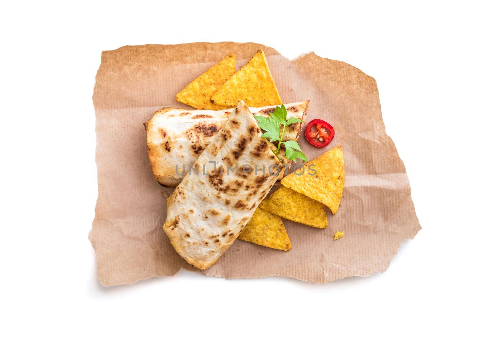 burrito with chips on parchment isolated on a white background