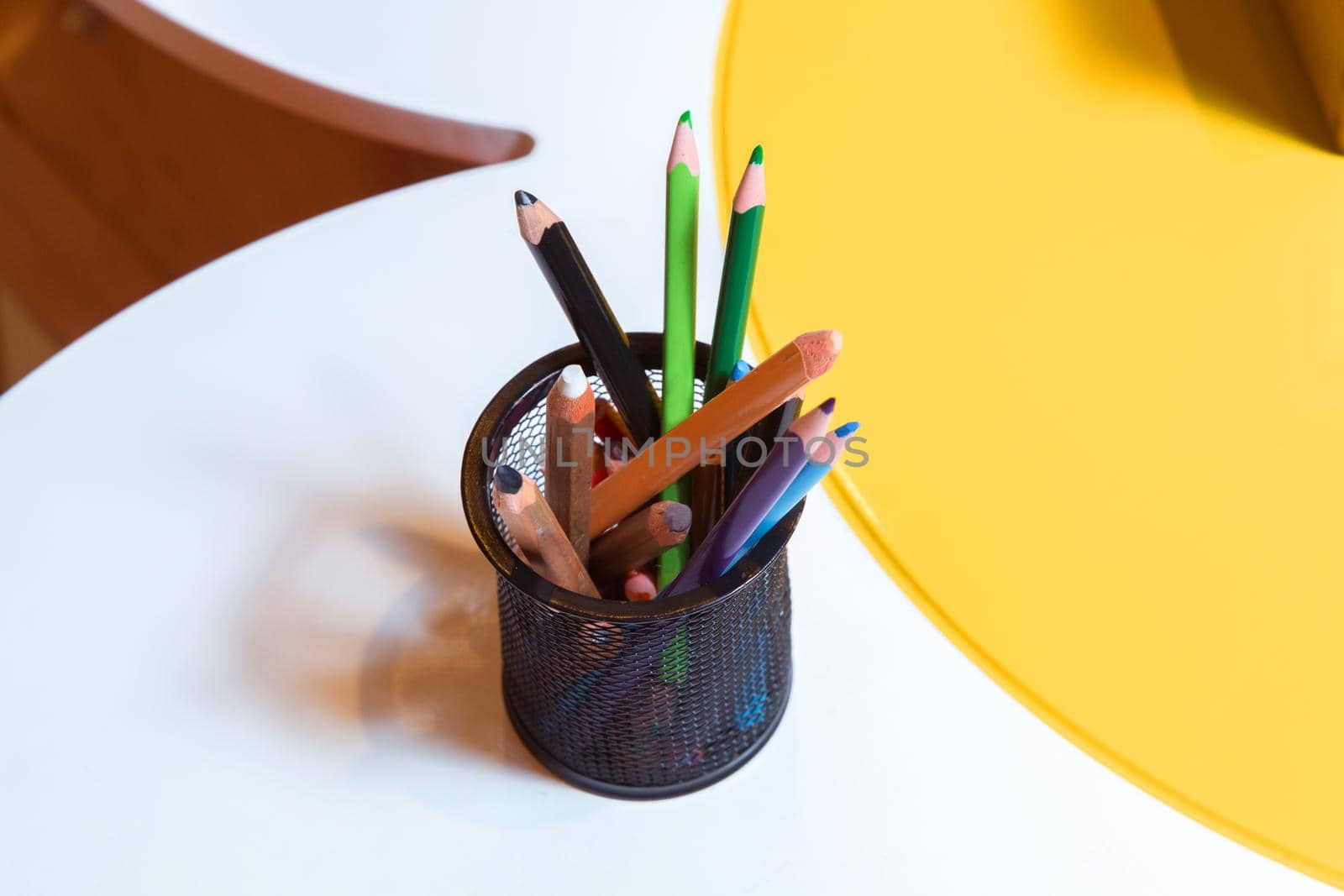 Crayons in a bowl . Color pencils for the drawing, located in a support as a vase . Multicolored pens by Adil_Celebiyev_Stok_Photo