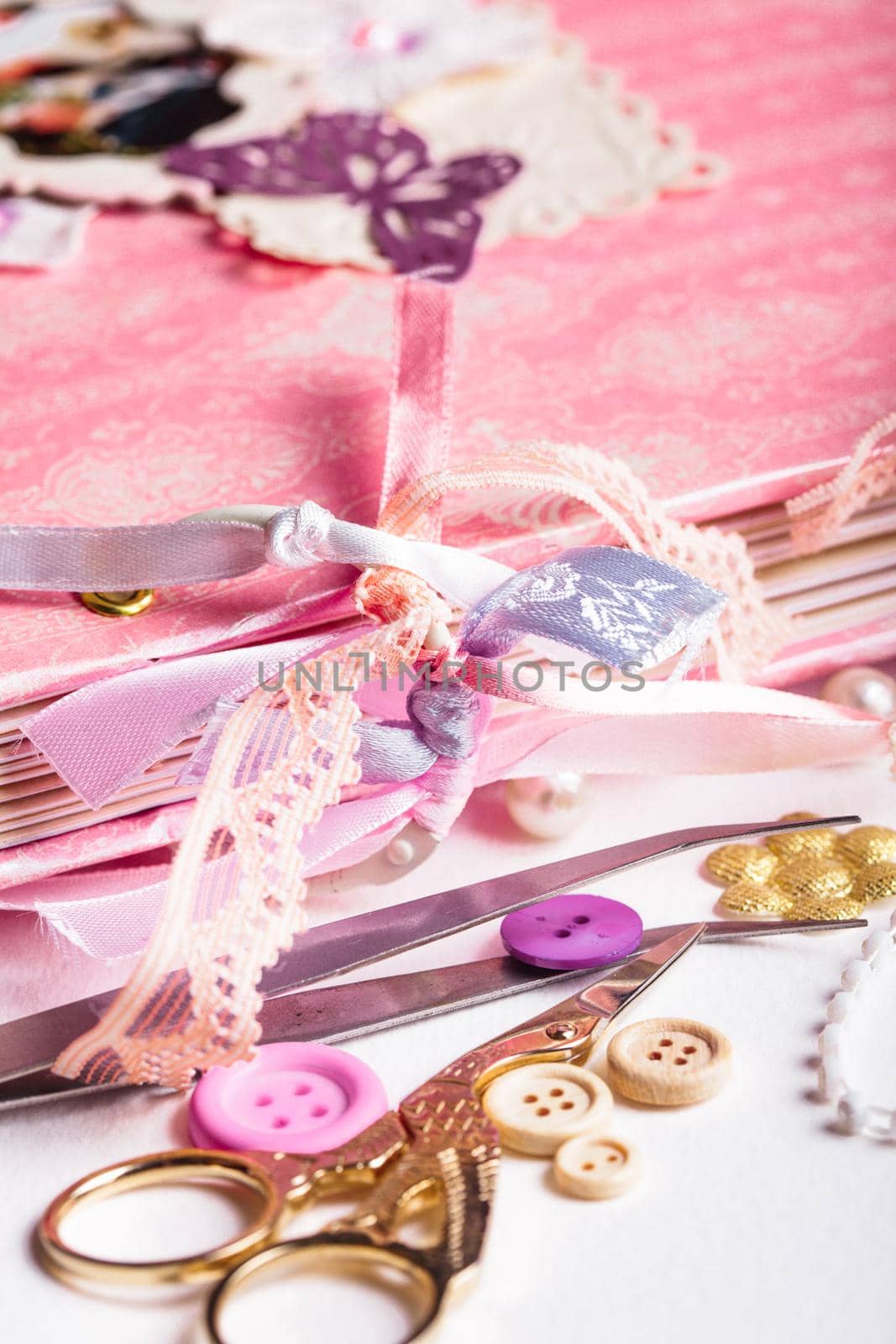 making scrapbooking album with rings and decorations on the table and tools