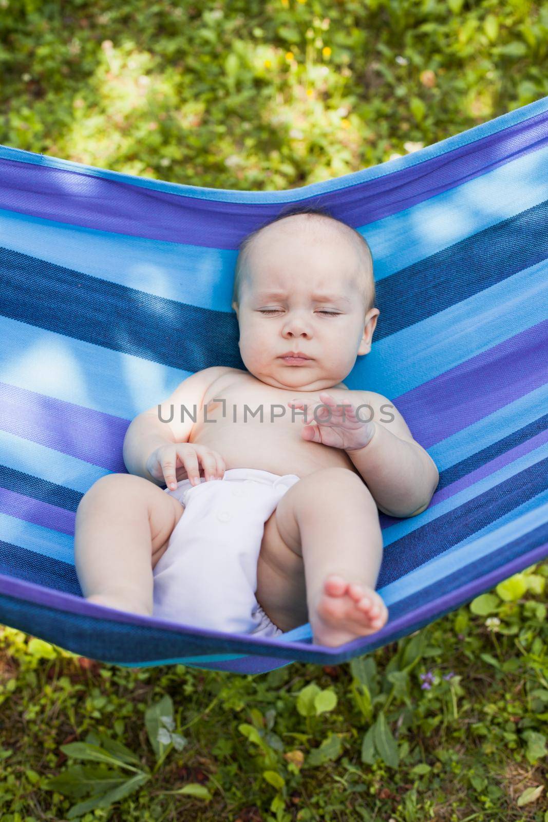 Baby in a hammock nave a daytime naps outdoors
