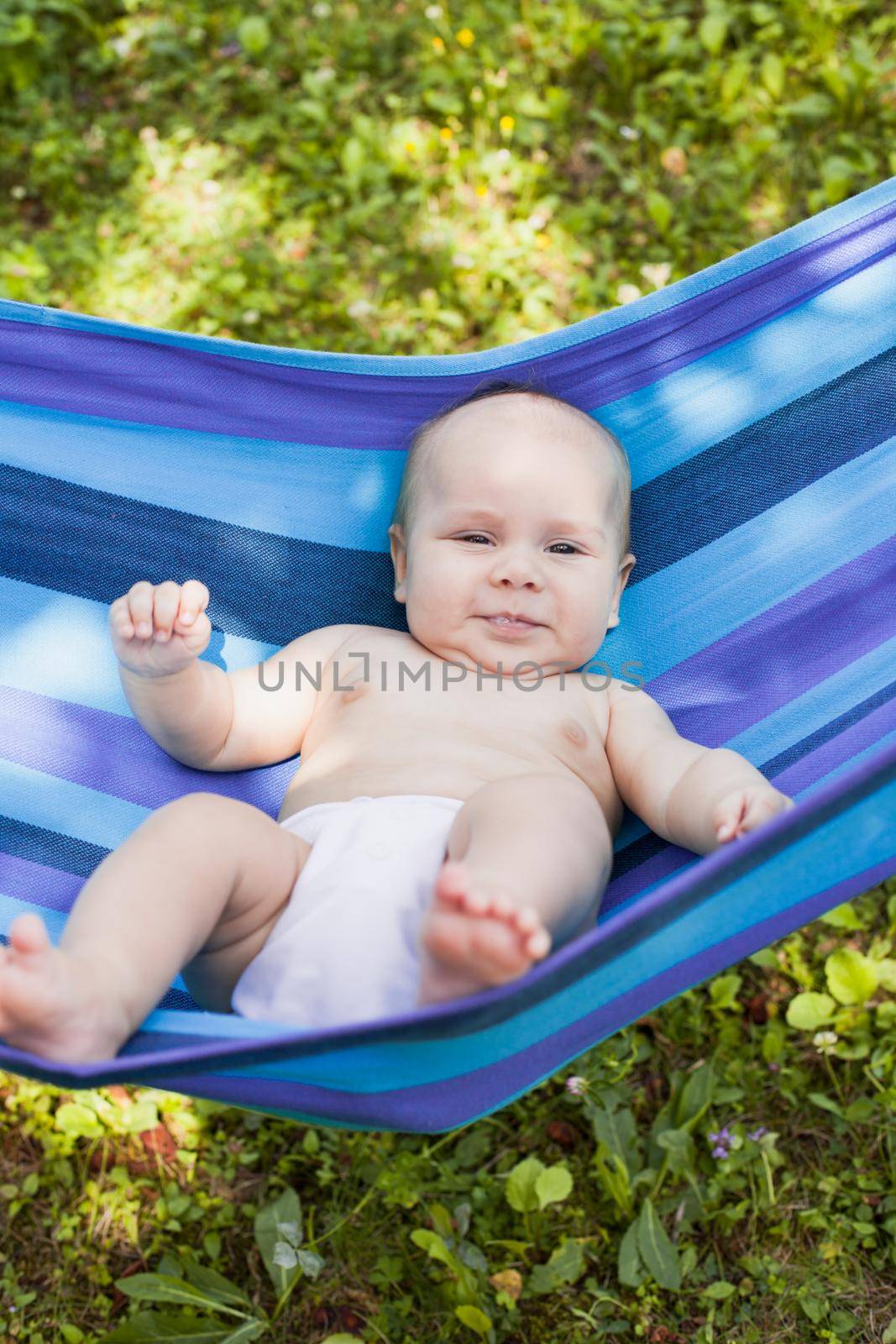 Baby in a hammock enjoys and relaxing