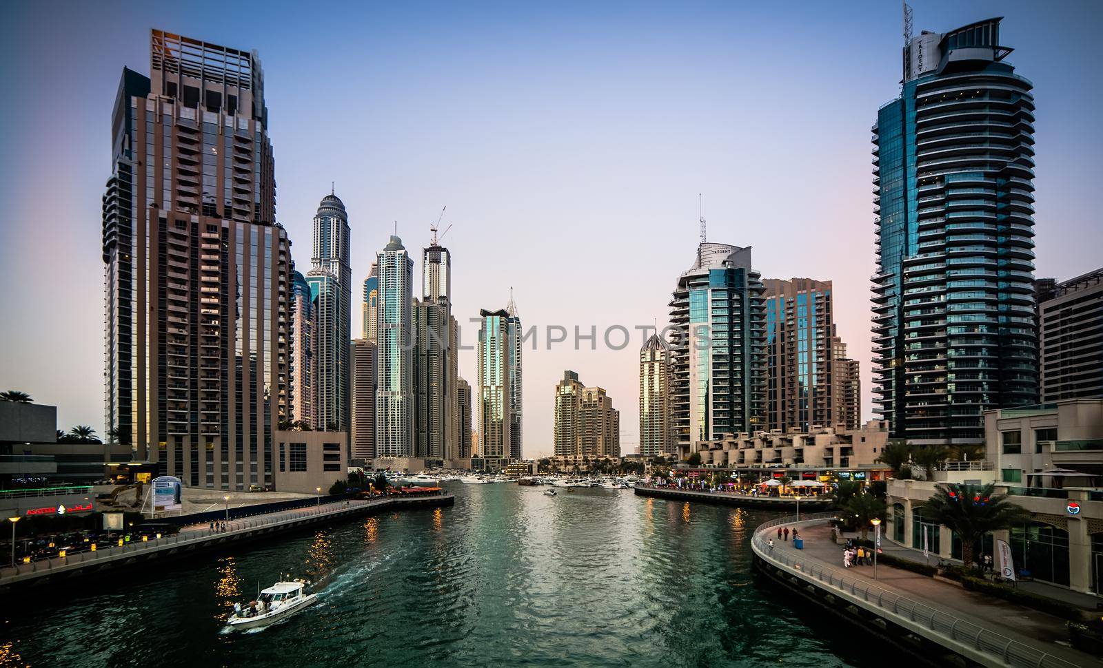 Dubai, United Arab Emirates - December 14, 2013: Panoramic view with modern skyscrapers and water channel of Dubai Marina in evening, United Arab Emirates