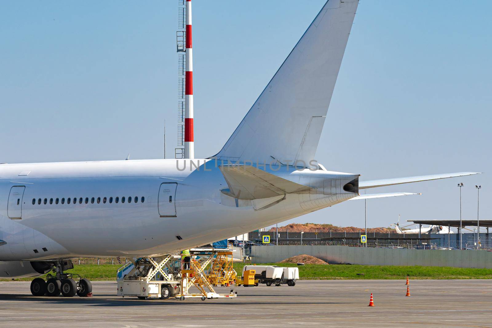 Airplane is parked near gate of airport terminal by Fabrikasimf