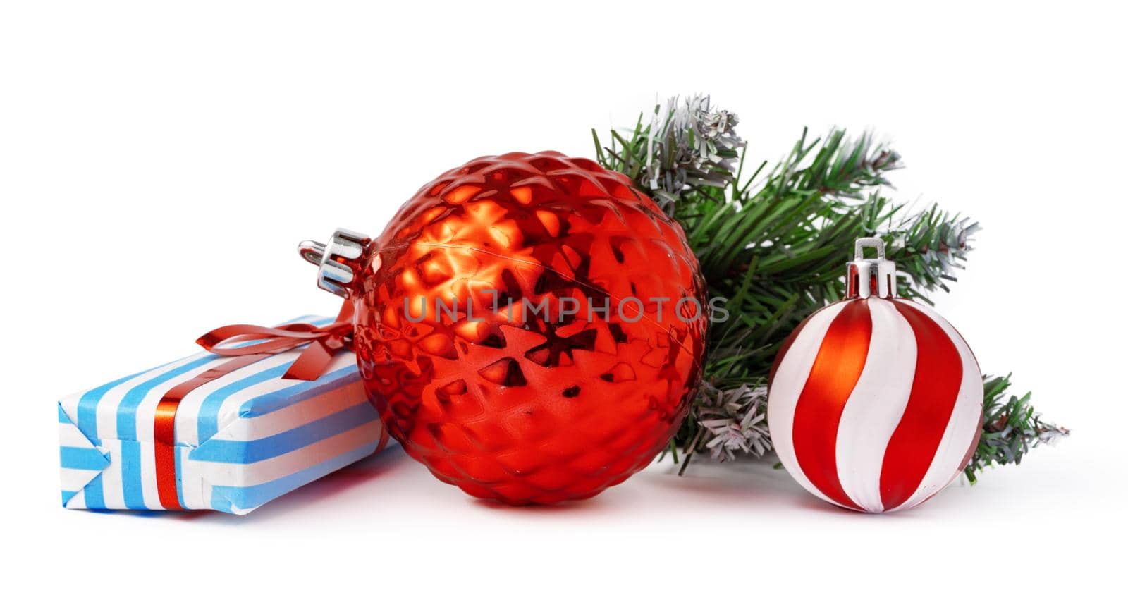 Christmas baubles and festive gift box isolated on white background, close up