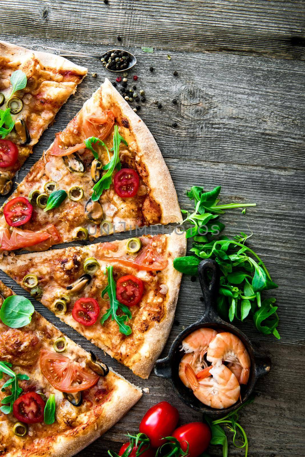 delicious pizza with seafood on wooden table