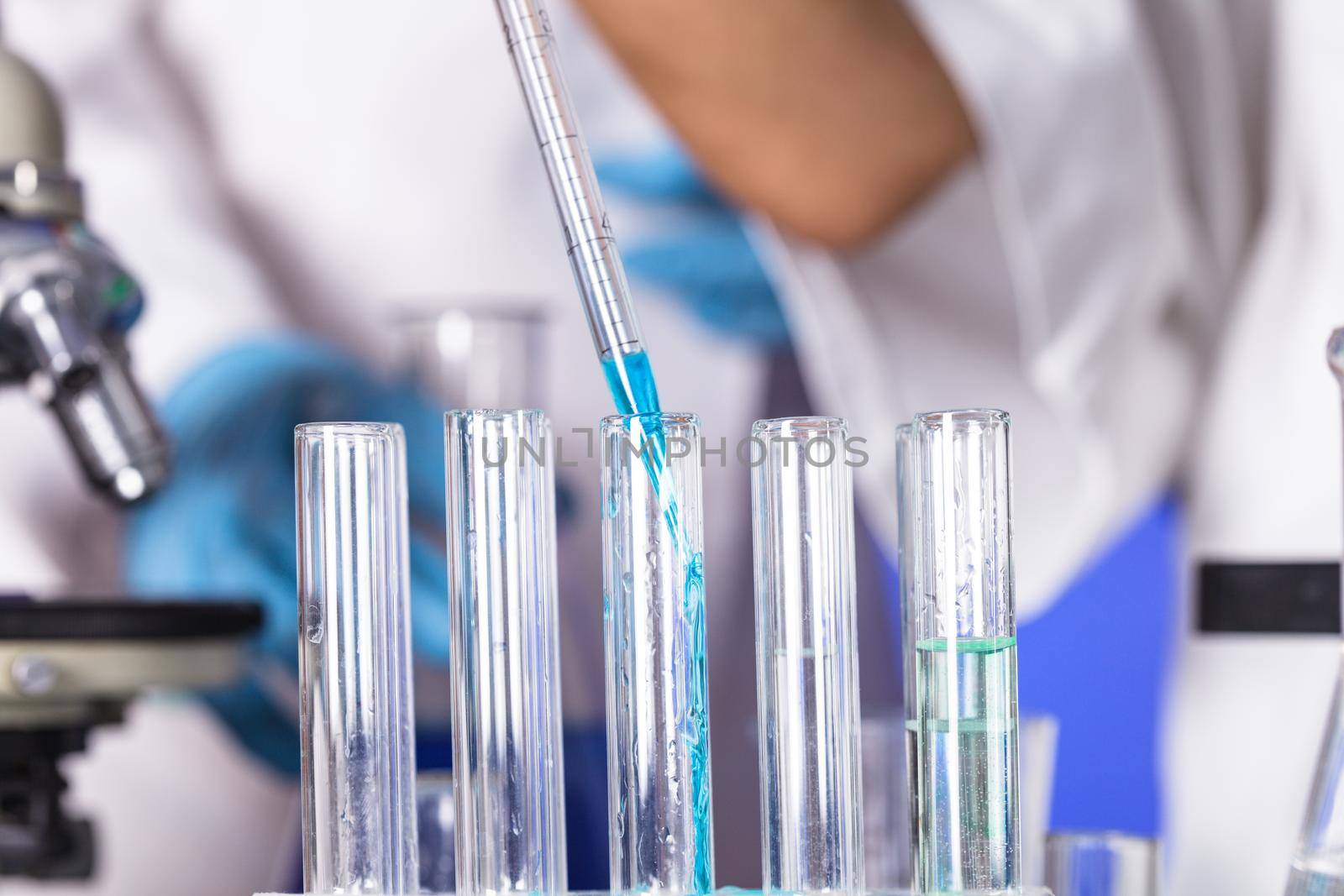 The blue drop from pipette in laboratory tubes