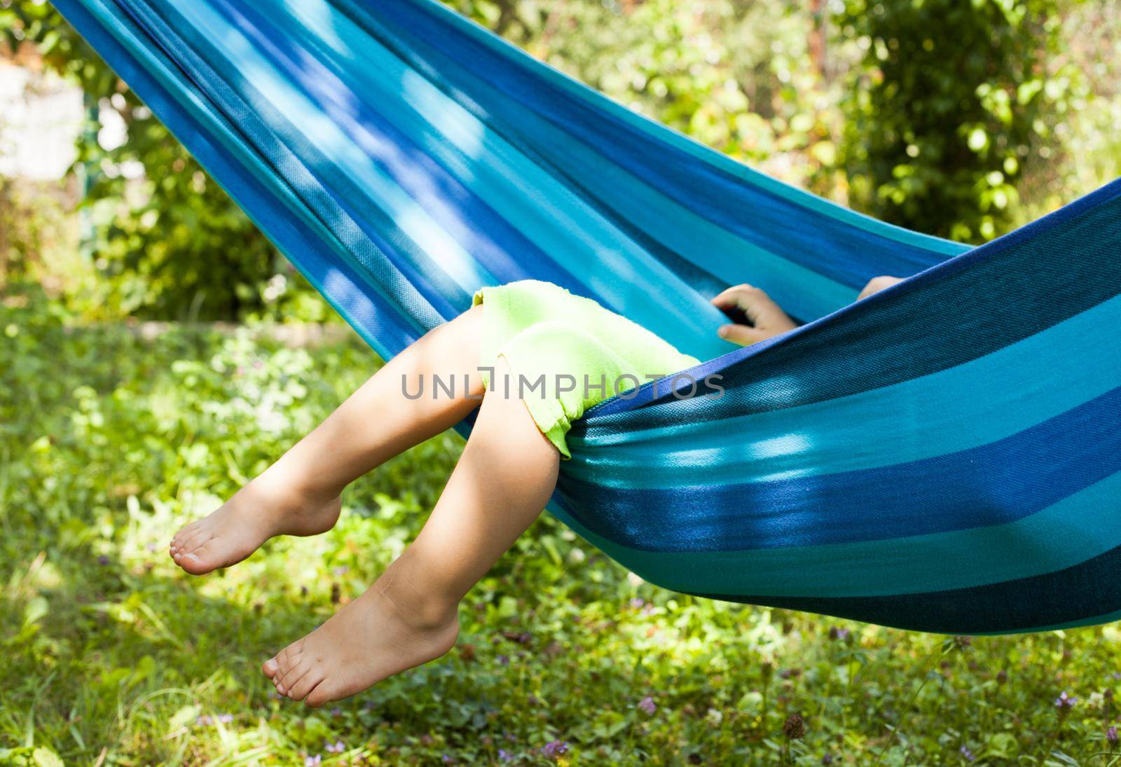 Little girl in a hammock, legs dangle