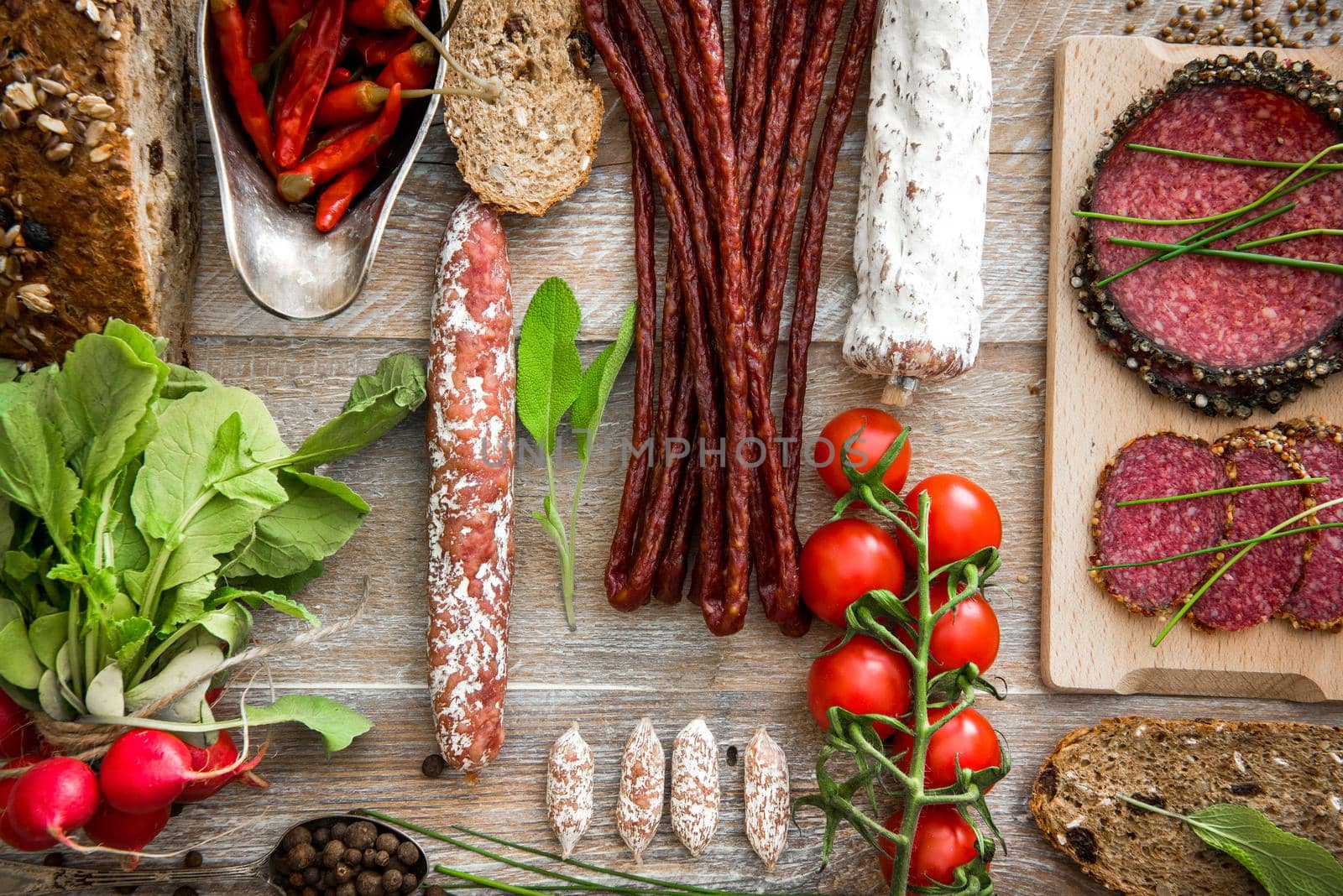 dried salami and vegetables on a wooden rustic table