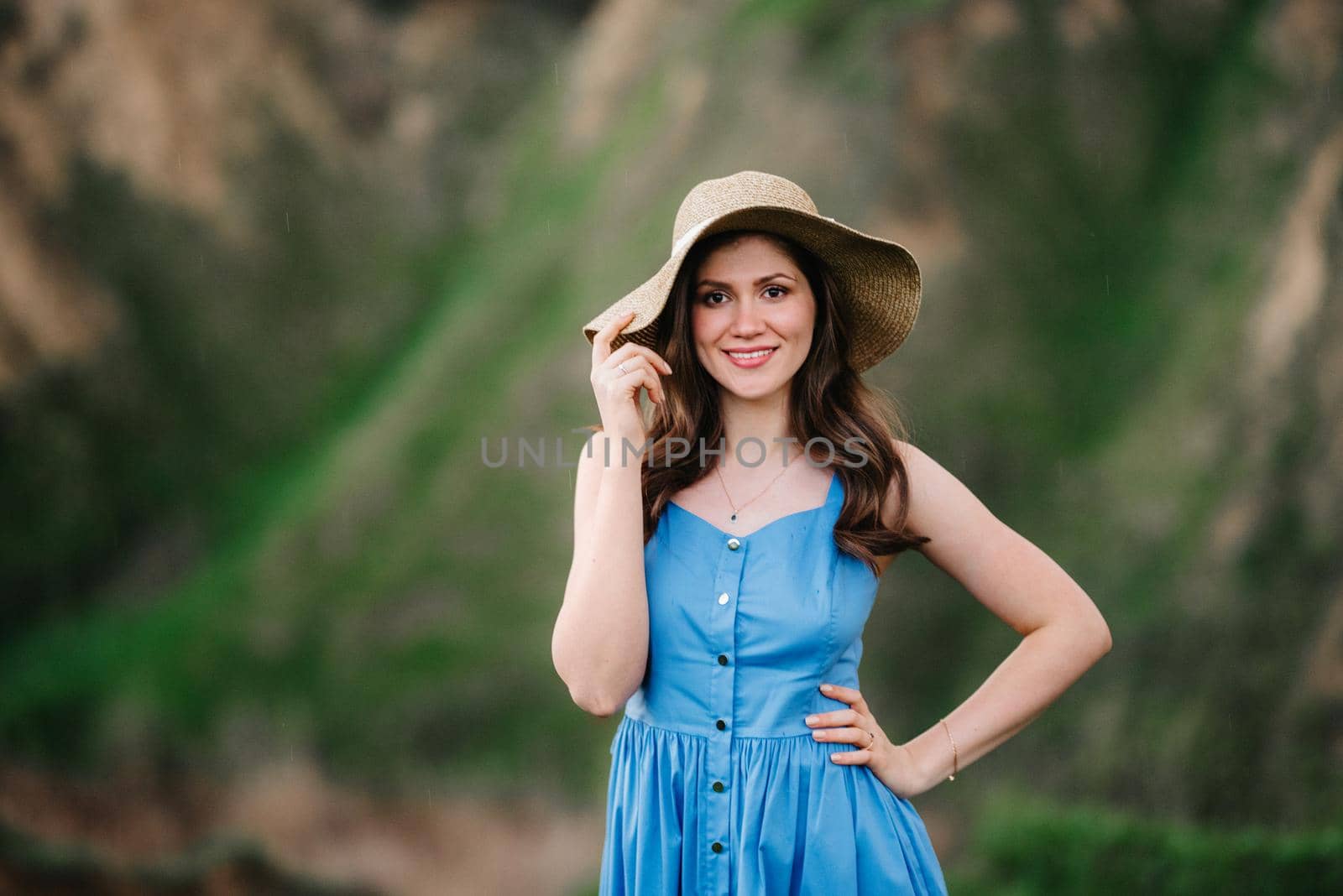 young girl in a straw hat with large brim on mountain slopes by Andreua