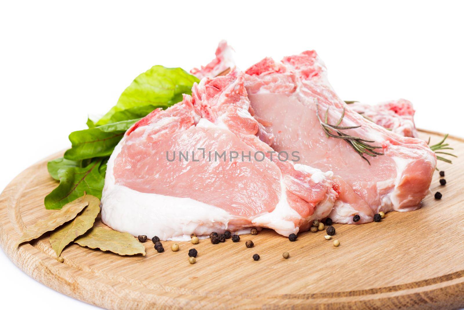 Raw loin slices on the board isolated on white