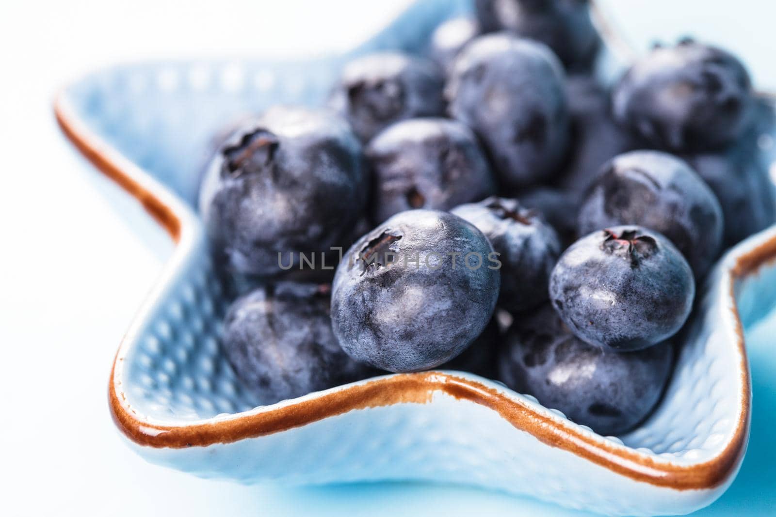 Blueberries close up in a blue bowl