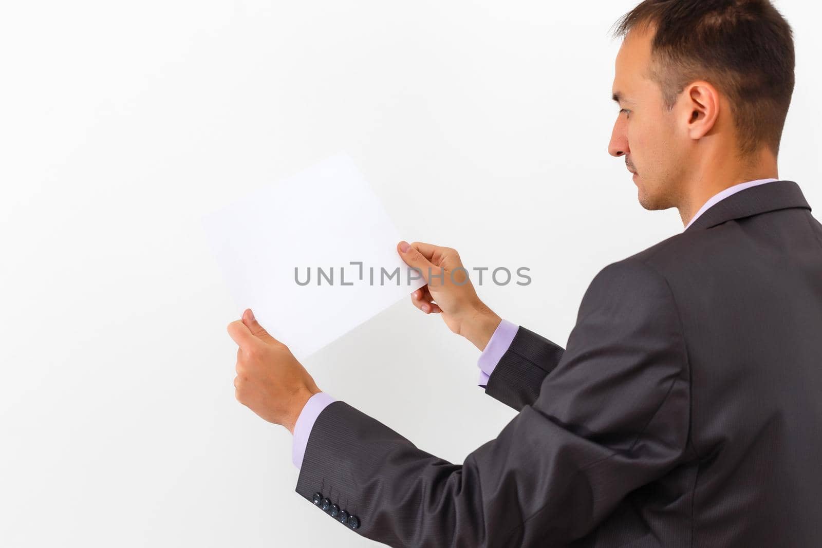 businessman holding a blank white board, signboard, showing an emty bill board against white background