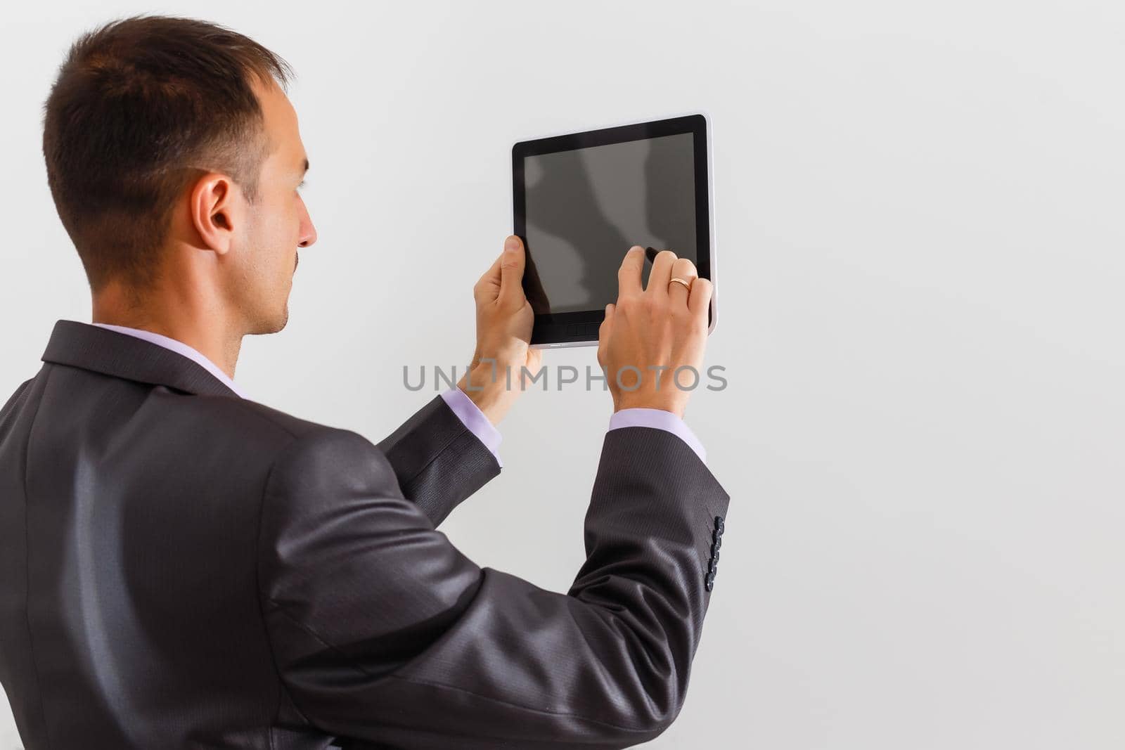 businessman holding a blank white board, signboard, showing an emty bill board against white background