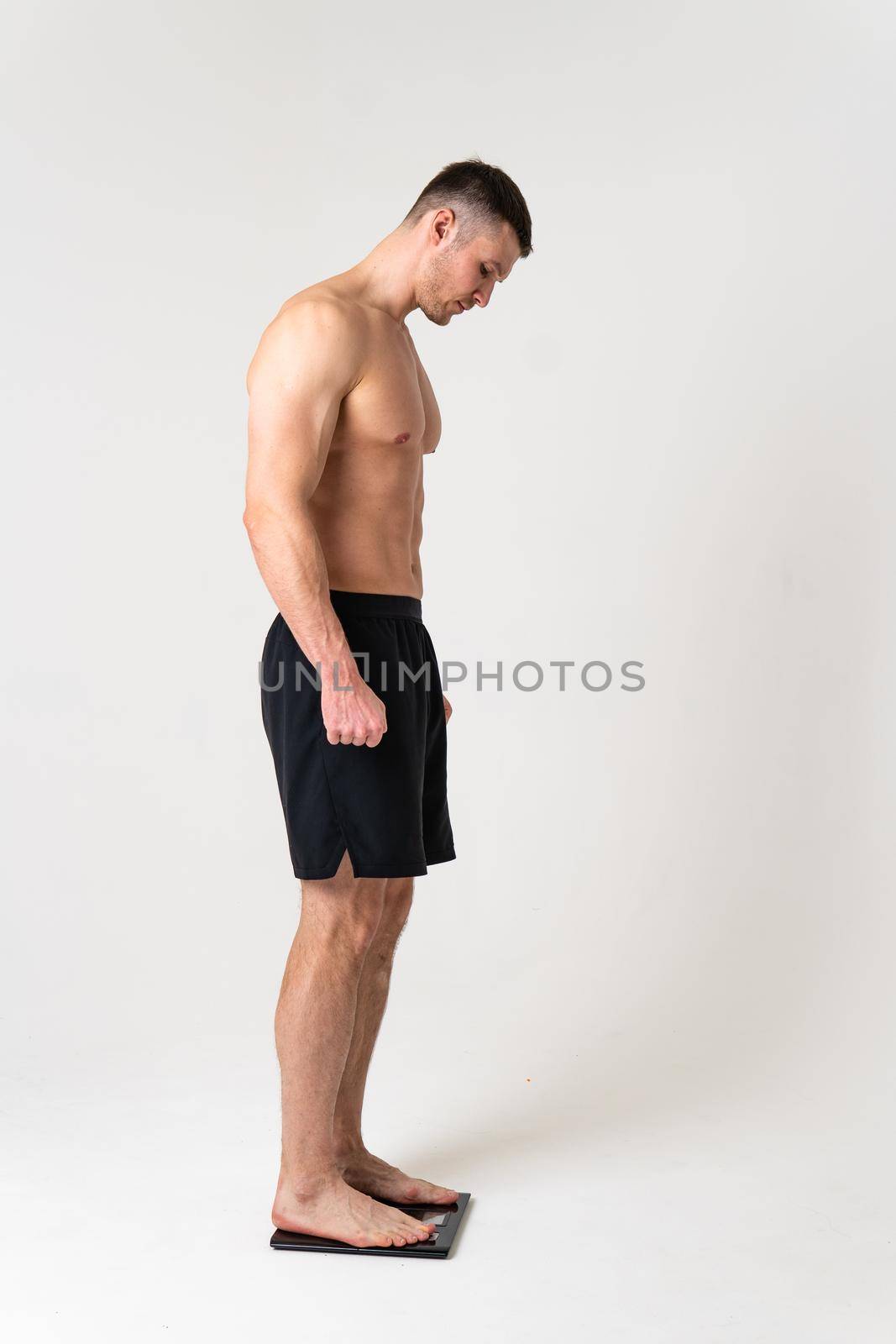 Man with weights health pondered, health and sports on a white background pain body painful, man massage adult, muscular expression. Tension neck sickness, lower suffer attractive