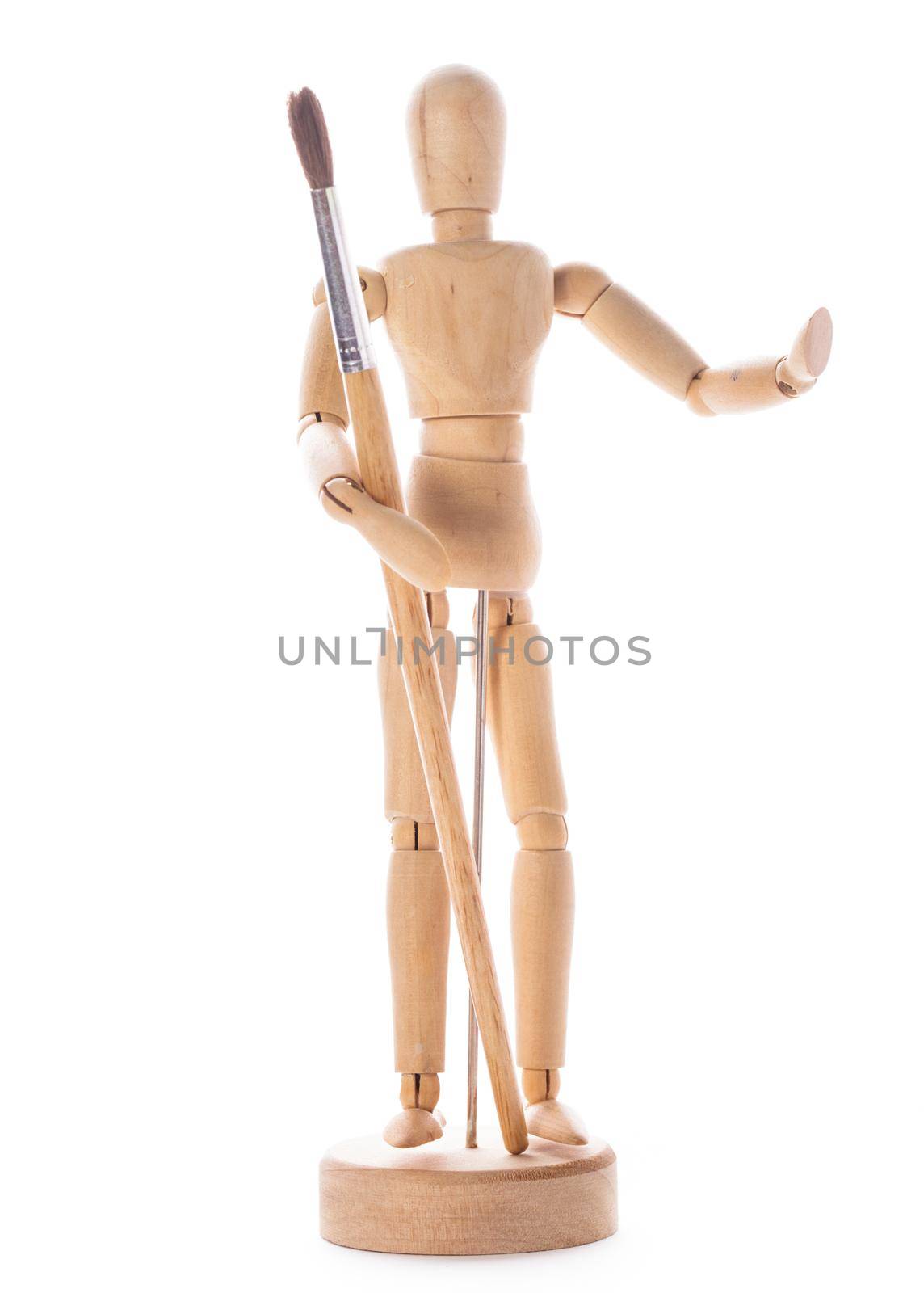 Art concept, wooden figure for modeling poses of human and paintbrush