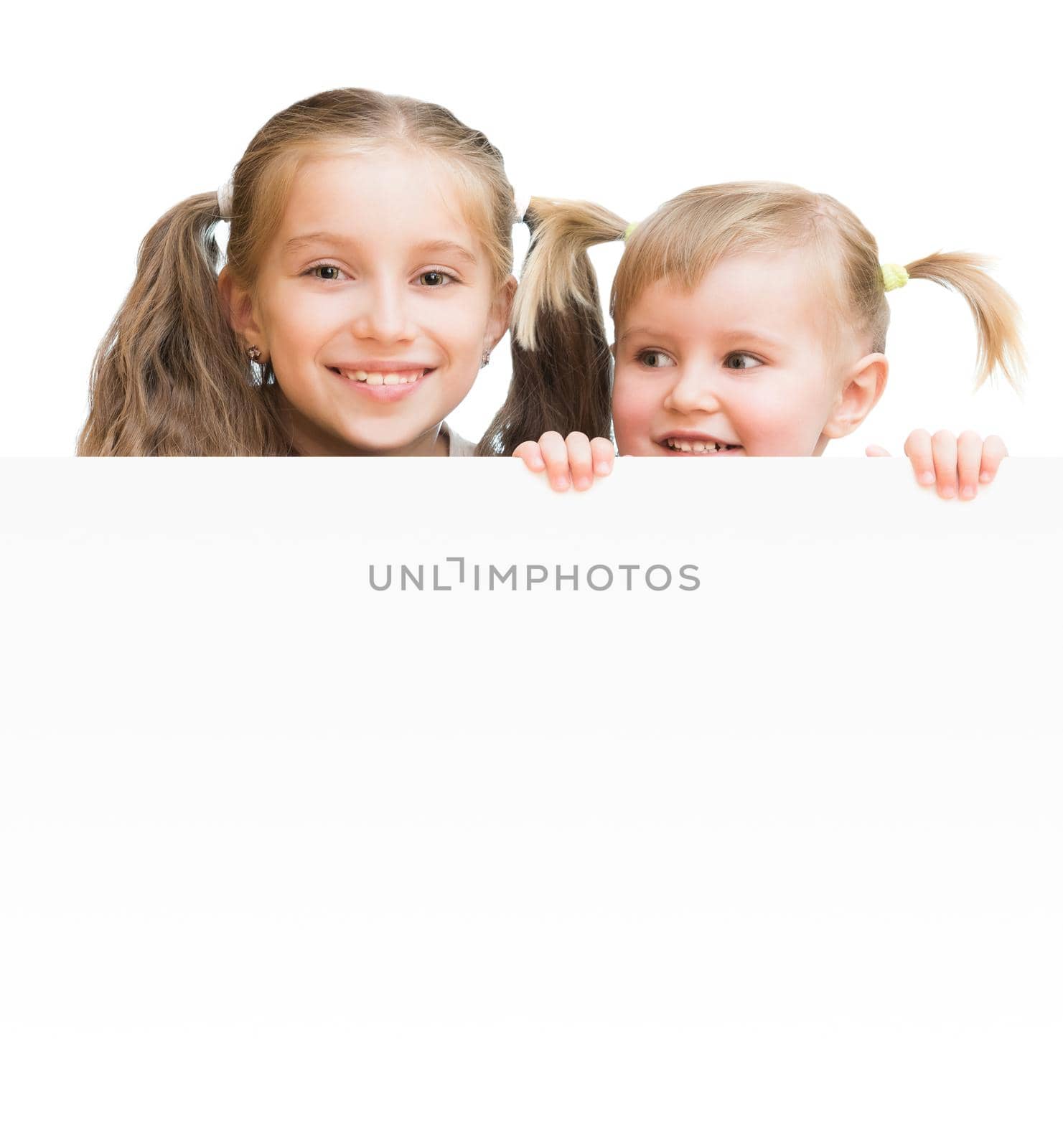 Beautiful sisters with board isolated on a white background
