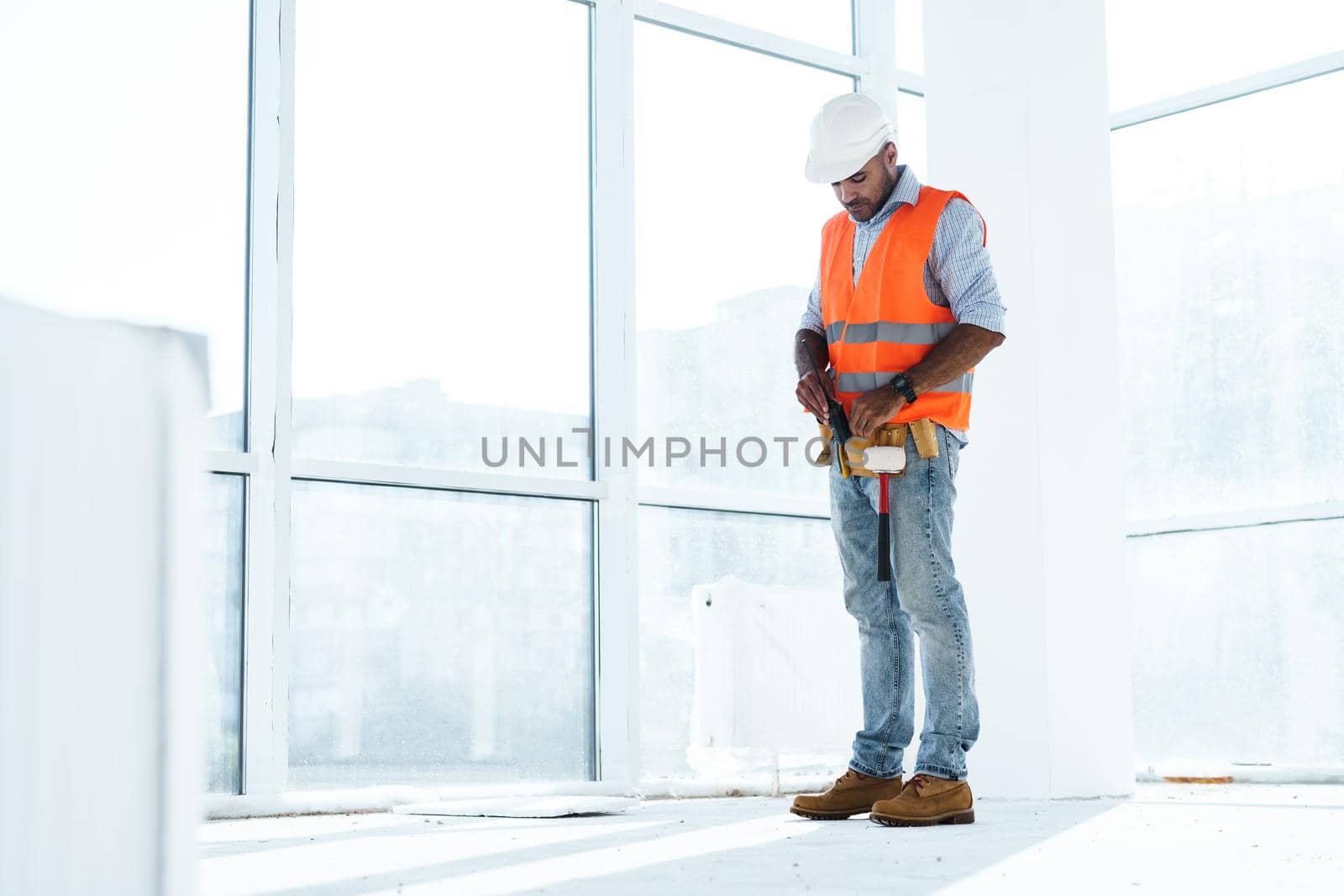 Portrait of young construction engineer wearing hardhat, close up