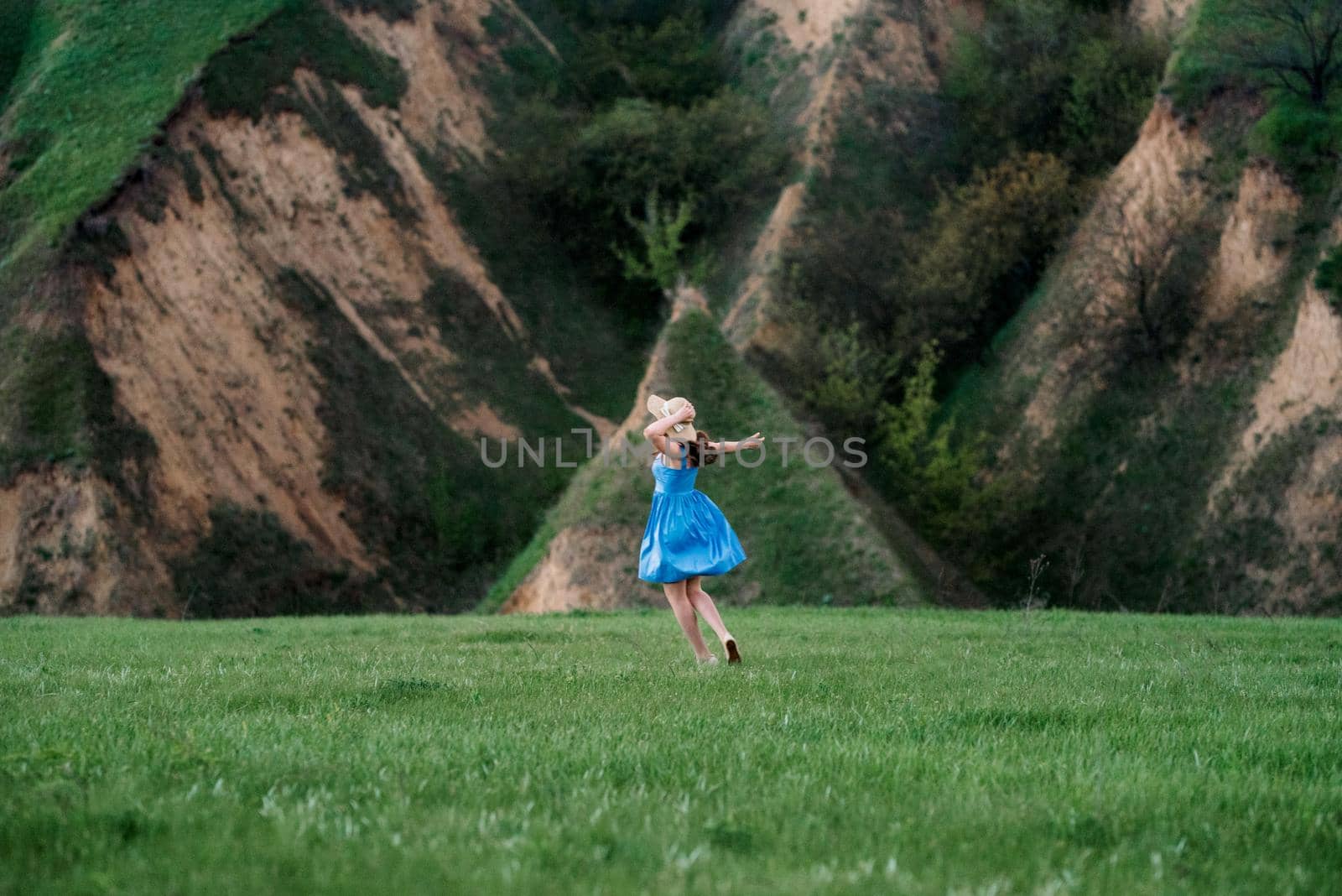 young couple a guy and a girl are walking in the mountain hills by Andreua