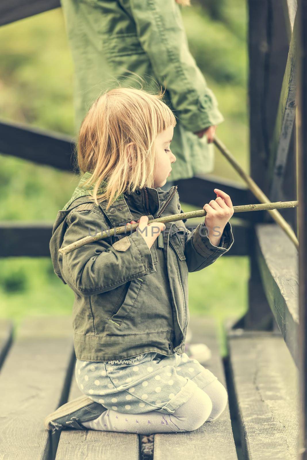 fisher girl carefully looking after the fishing rod