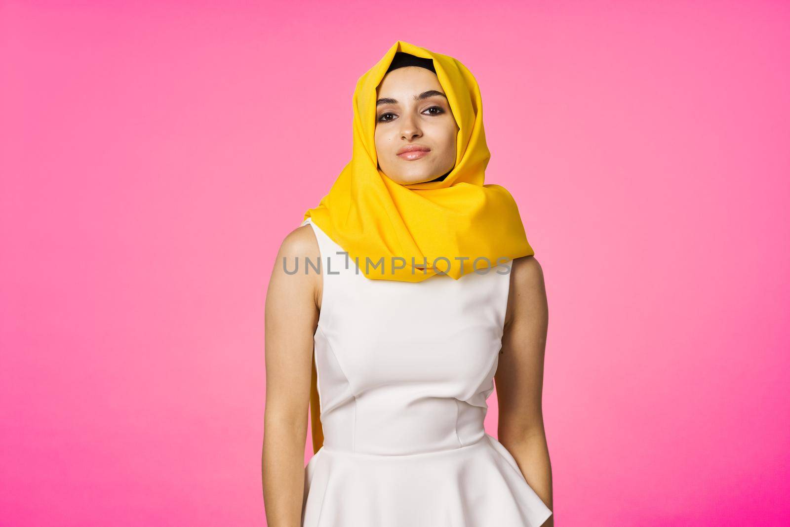 muslim woman in hijab posing fashion ethnicity pink background. High quality photo