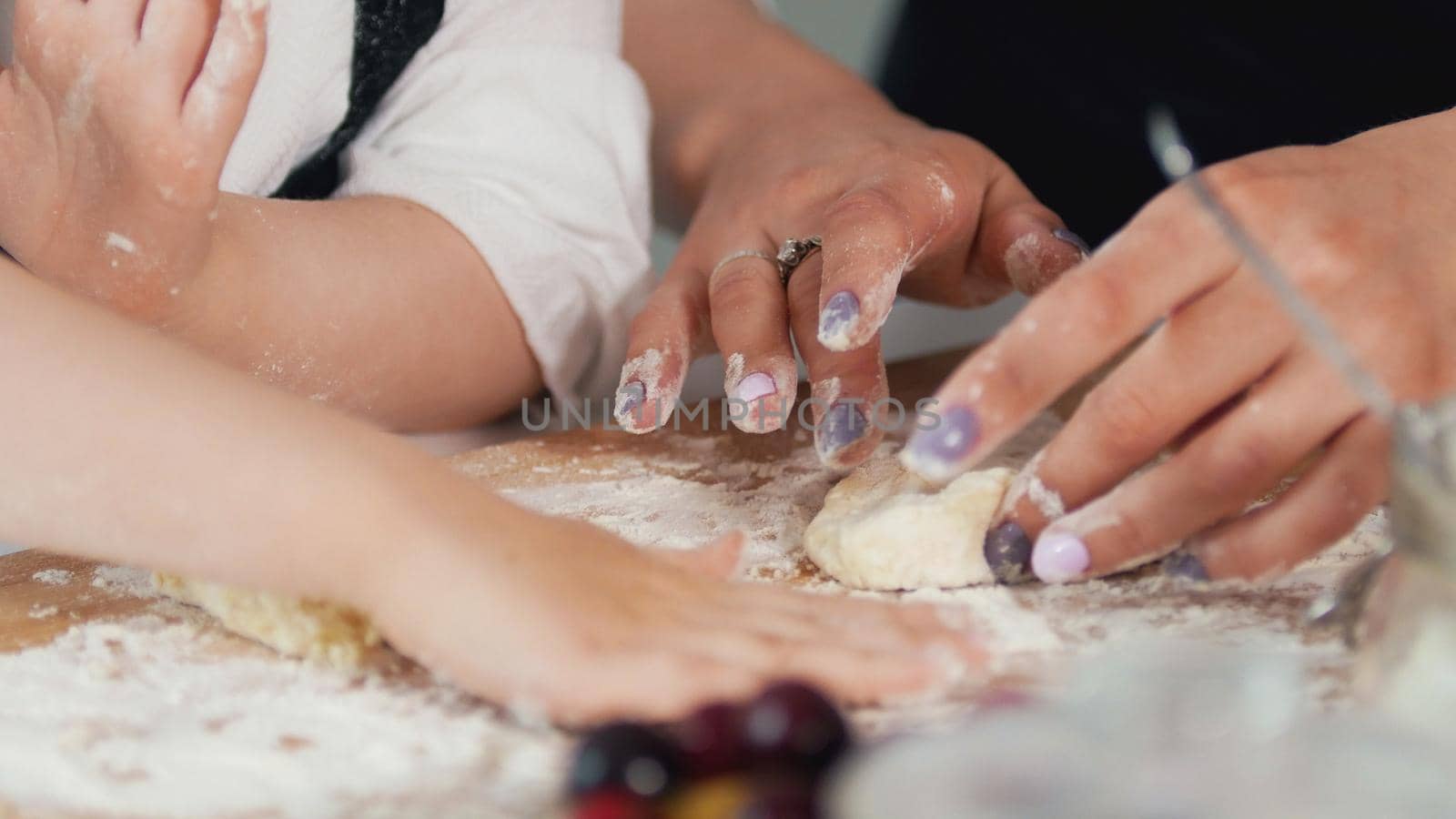 Woman's hands forming homemade pancakes from dough, close up