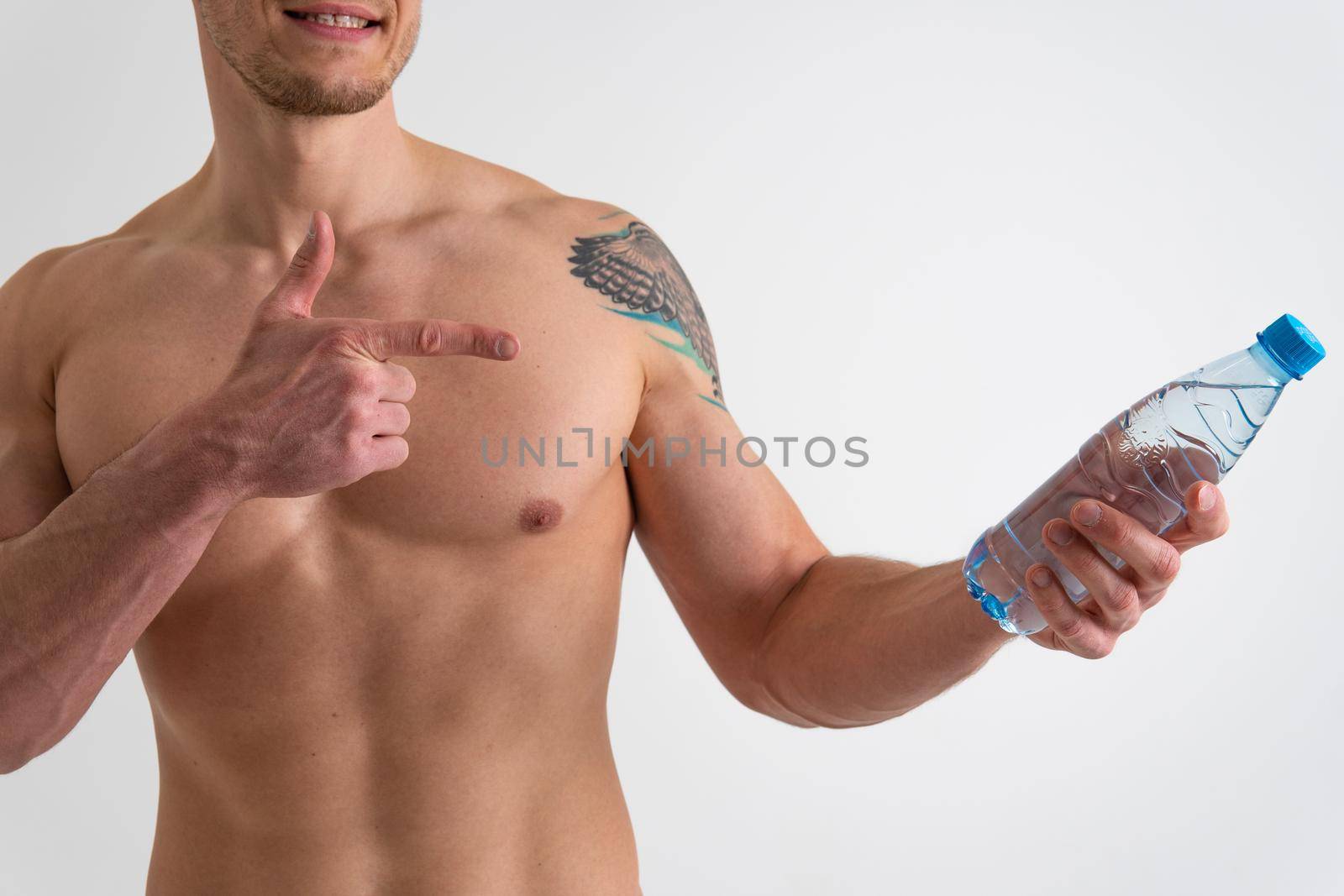 Male drink-water fitness is pumped with a towel on a white background isolated fitness muscular body, healthy sportswear Strength perfect, sportsman one muscle