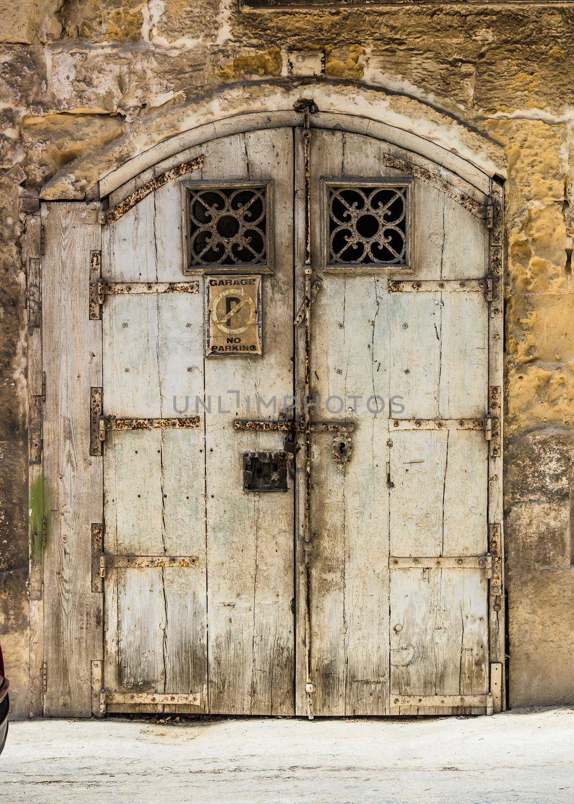 wooden garage doors in a street of Valletta historical center in Malta