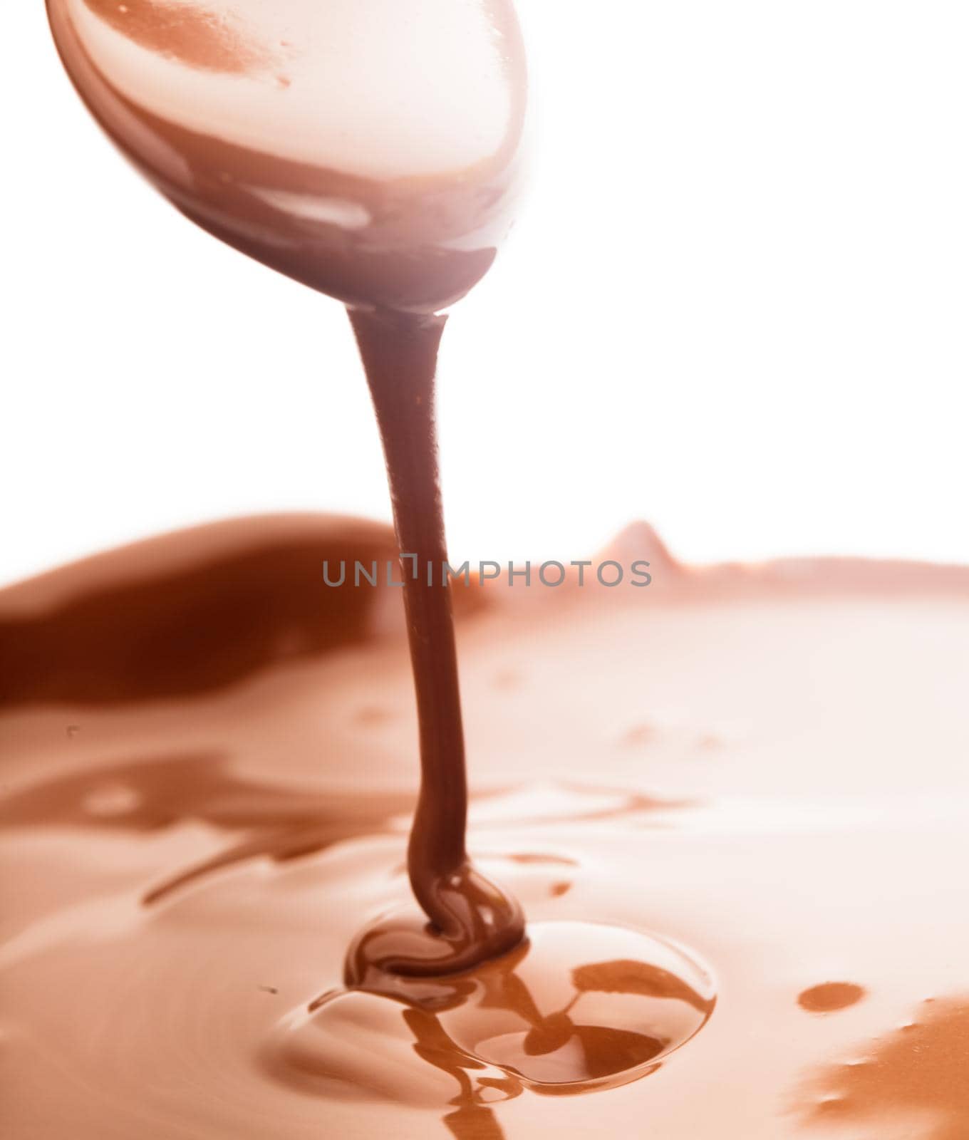 Chocolate flow close up with a spoon