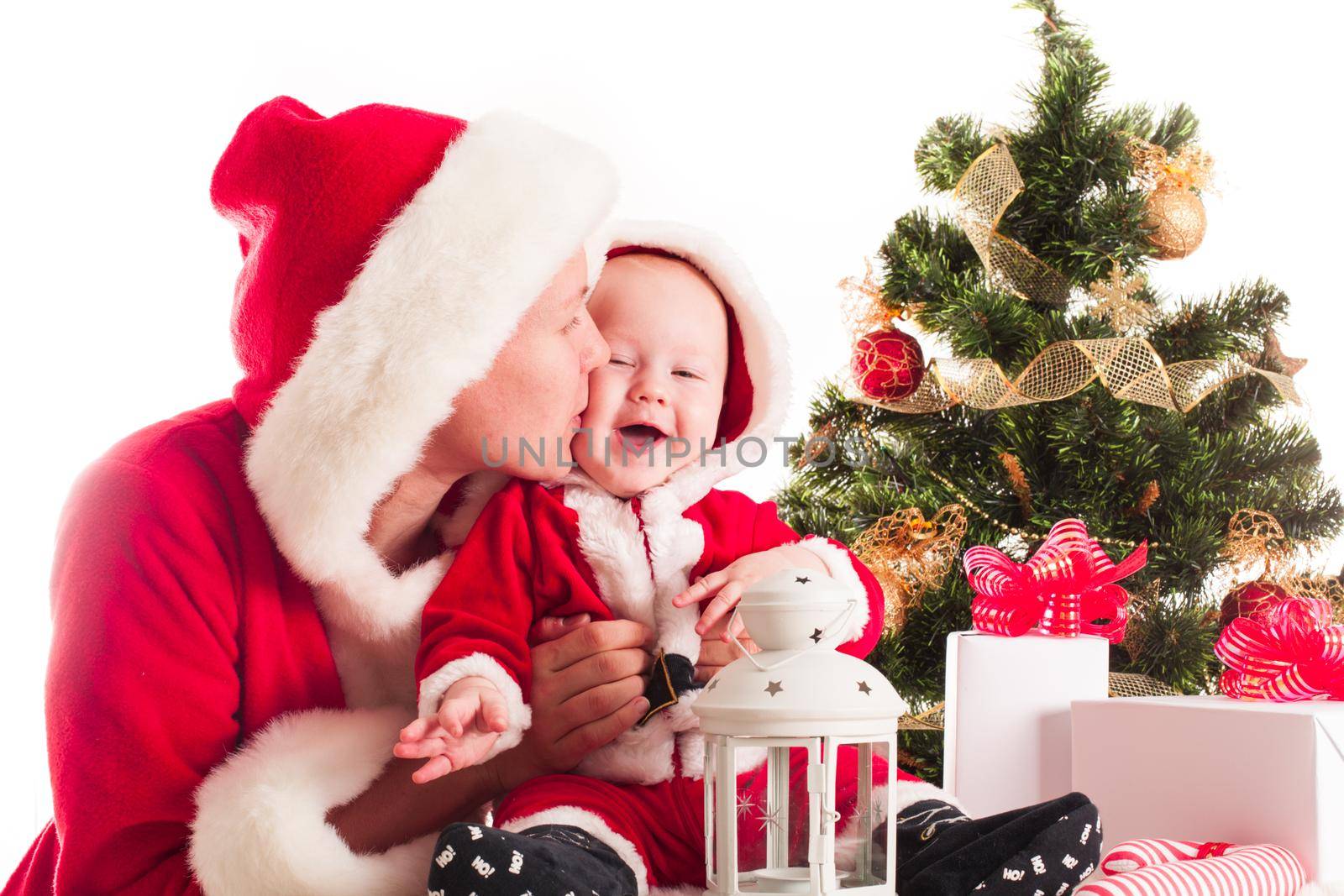 Christmas baby and mom under the fir tree isolated