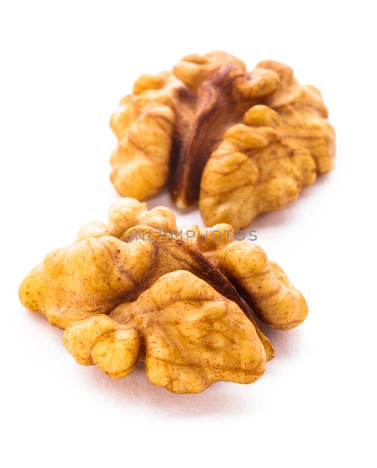 Peeled walnut close up isolated on white background