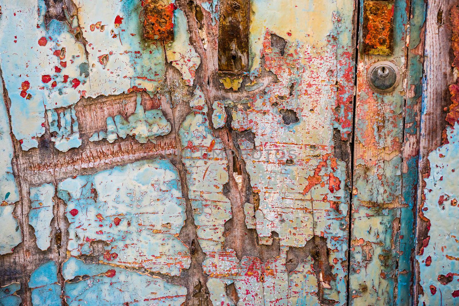 texture of old wooden door with crumbling paint layers