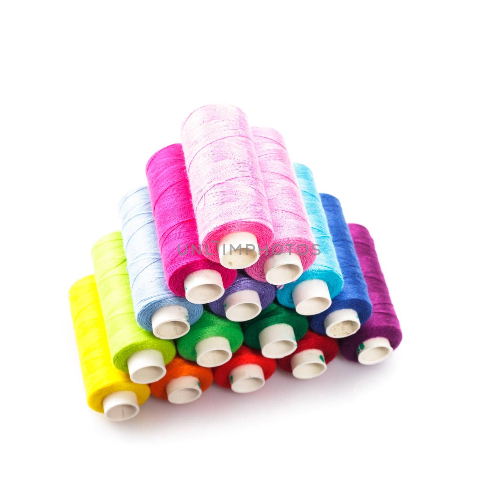 Sewing multicolored threads isolated on white background