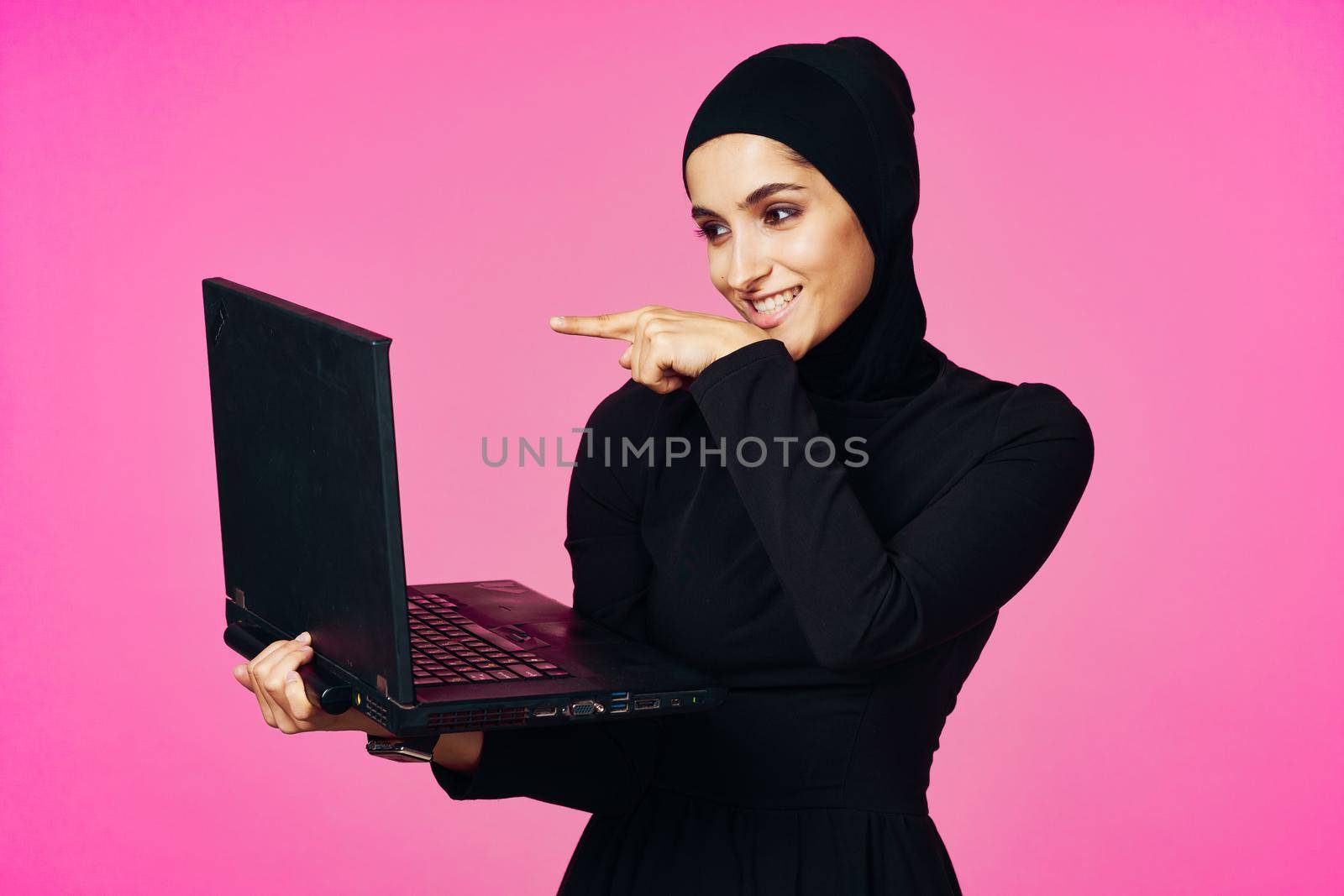 cheerful muslim woman with laptop education student internet technology. High quality photo